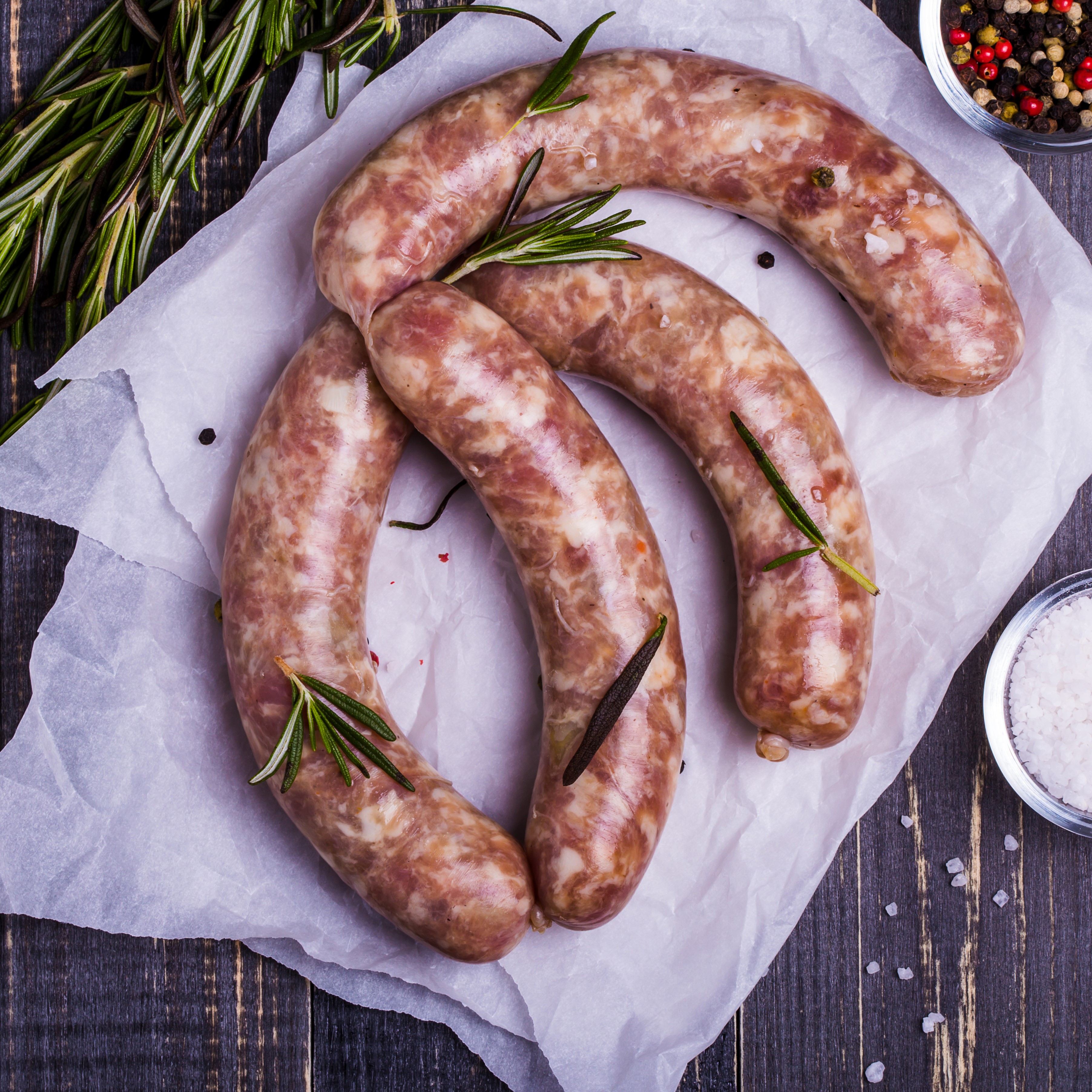 Raw sausages with rosemary and spices HD Wallpaper