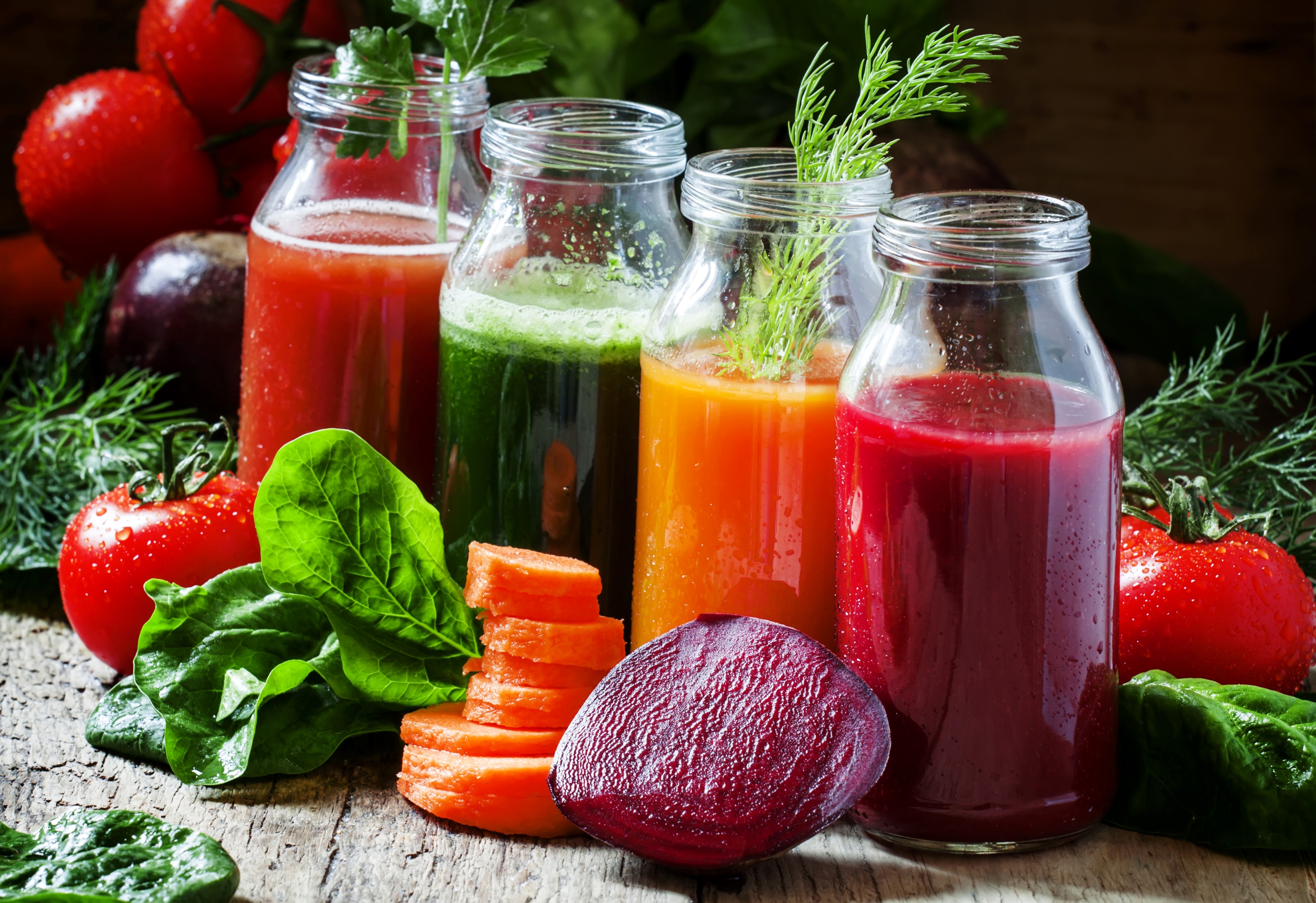 Four jars of vegetable juice with fresh vegetables HD Wallpaper