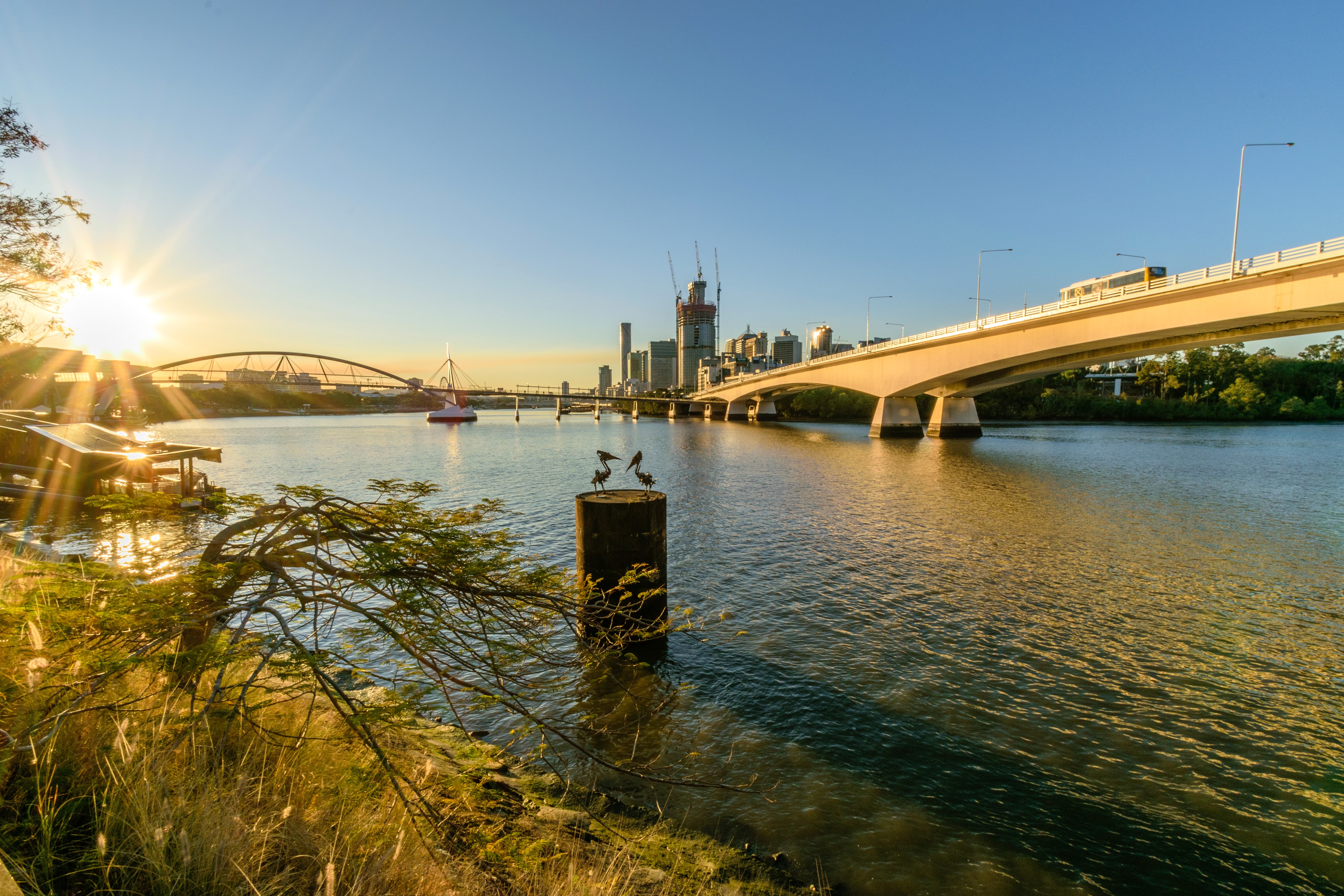 Brisbane River at Sunset with City Skyline and Bridges HD Wallpaper