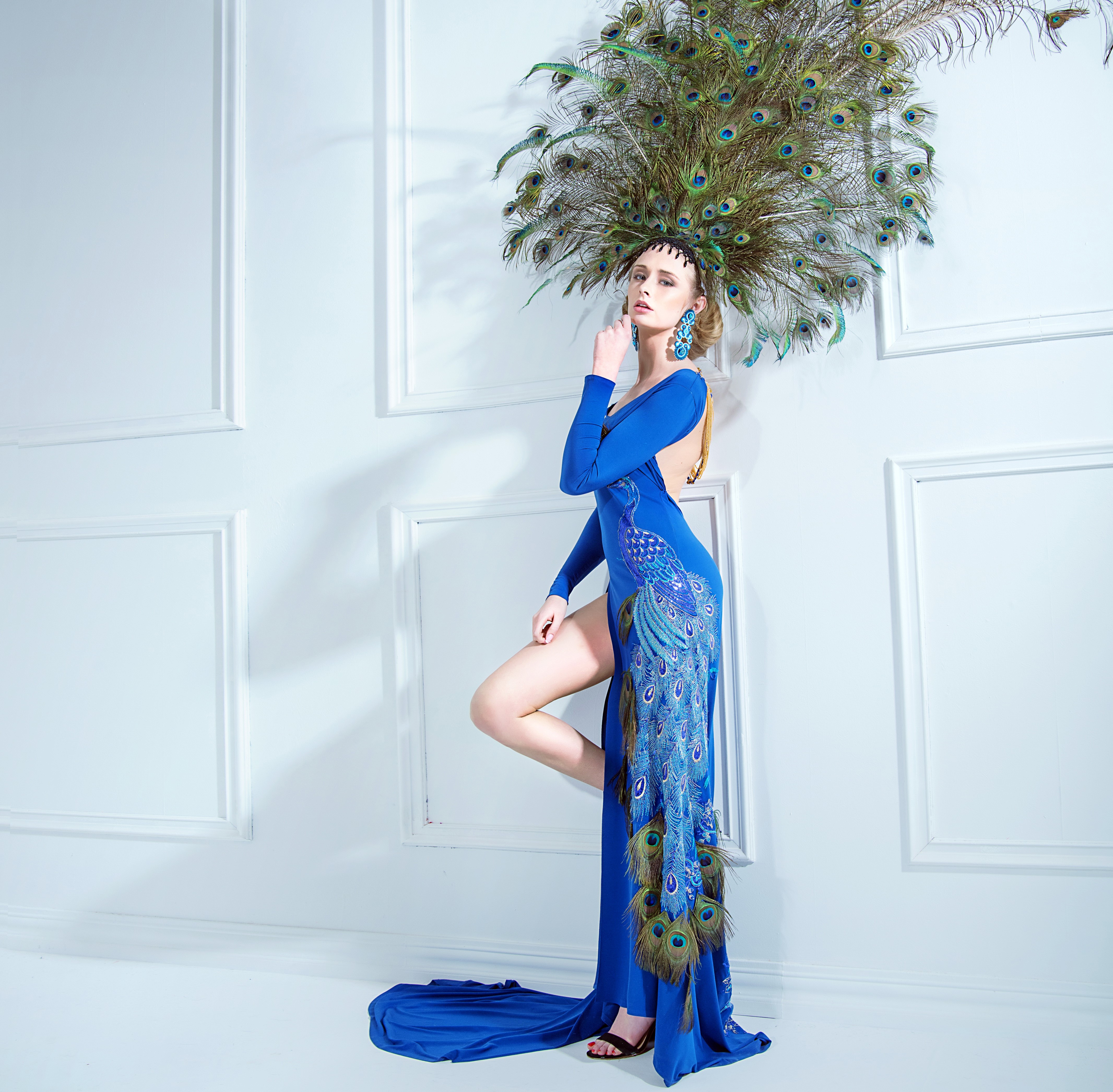 Woman in blue dress with peacock feathers HD Wallpaper