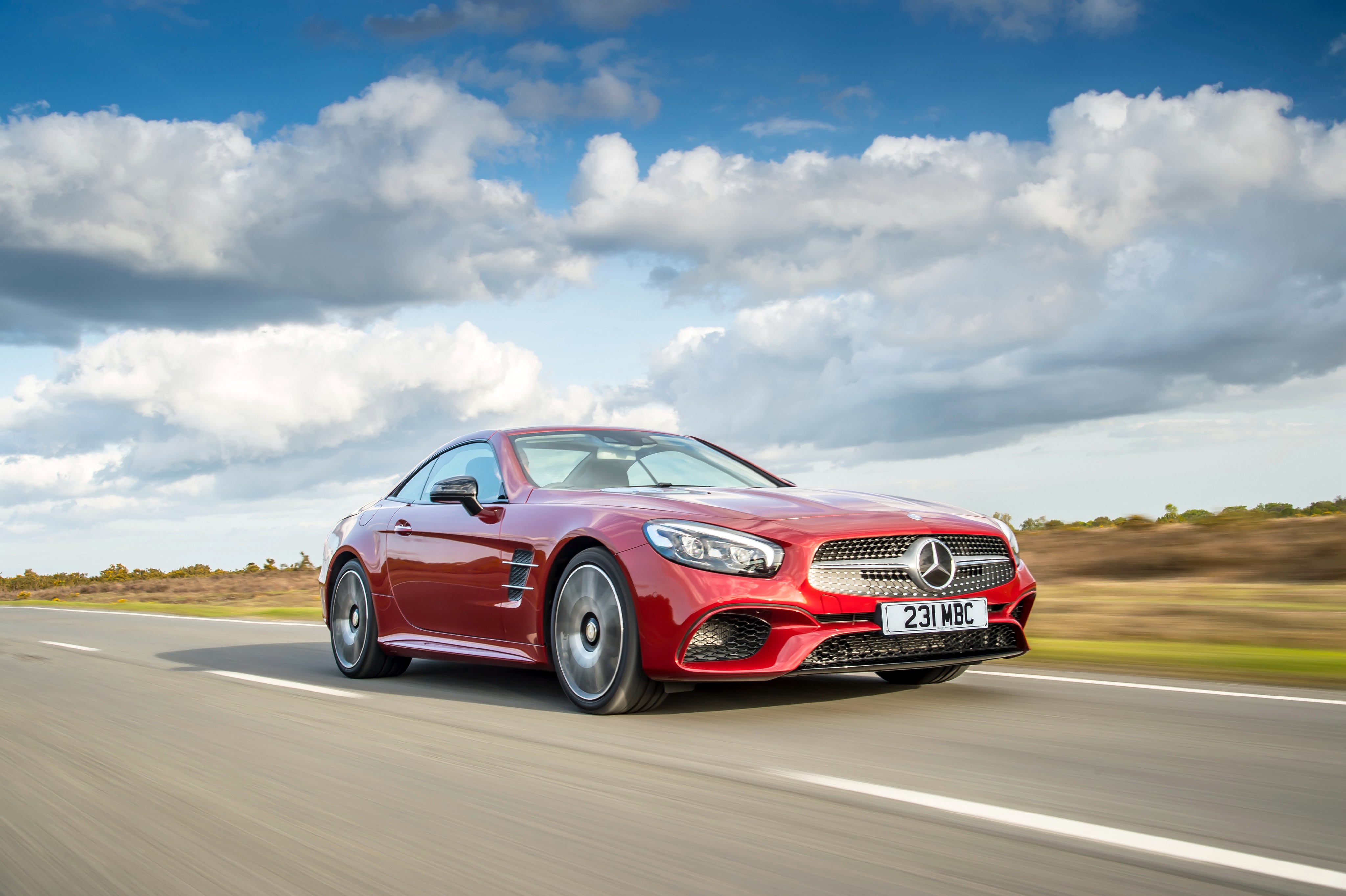 Red Mercedes-Benz SL 500 Driving on Road HD Wallpaper