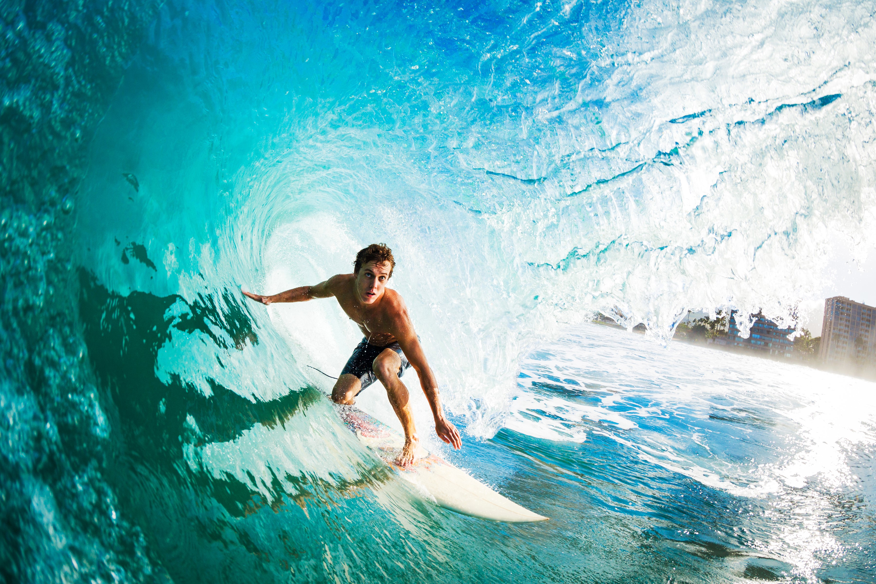 Surfer riding a wave inside a barrel HD Wallpaper