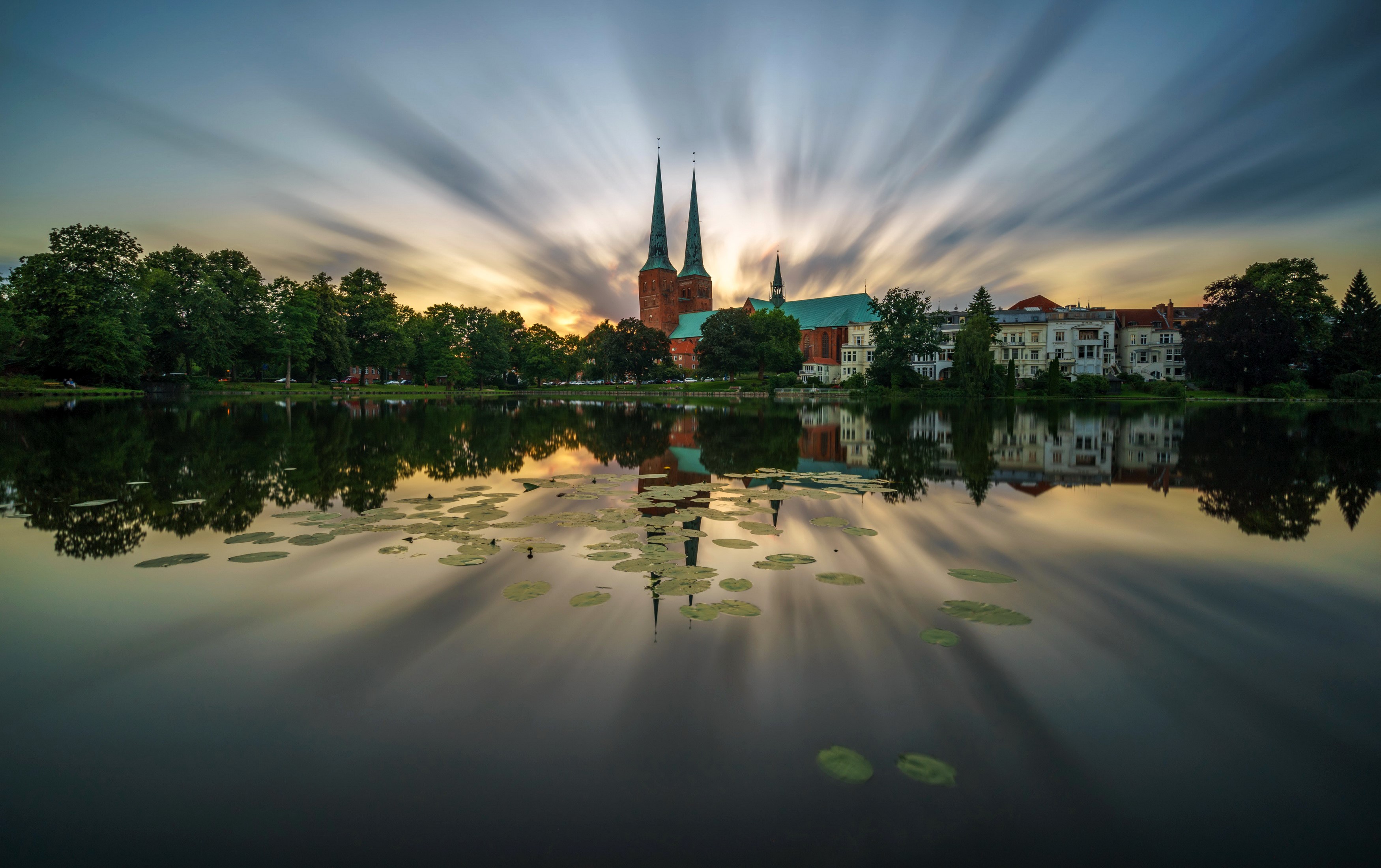 Lubeck Cathedral reflected in a pond at sunset HD Wallpaper