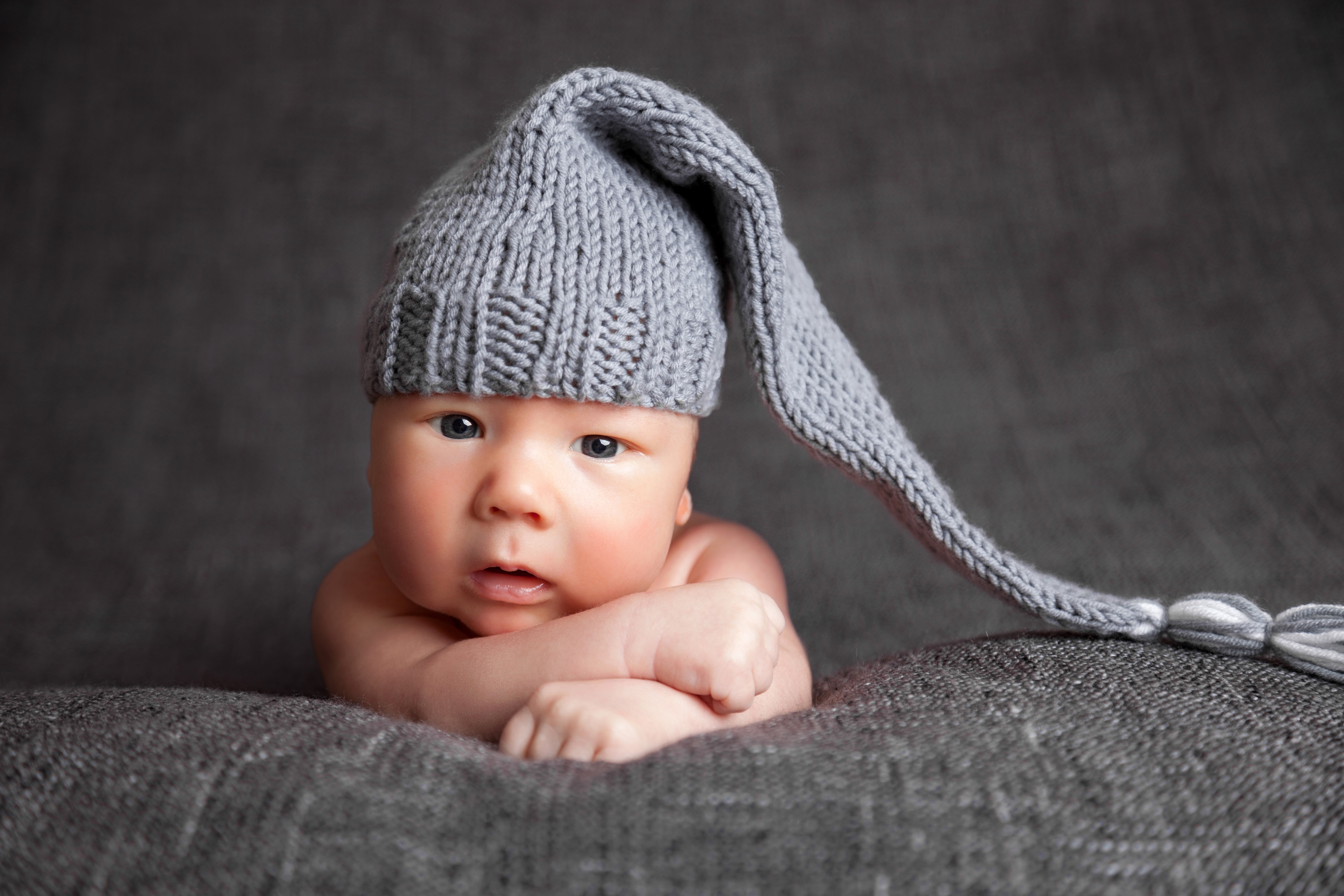 Infant wearing a gray winter hat HD Wallpaper