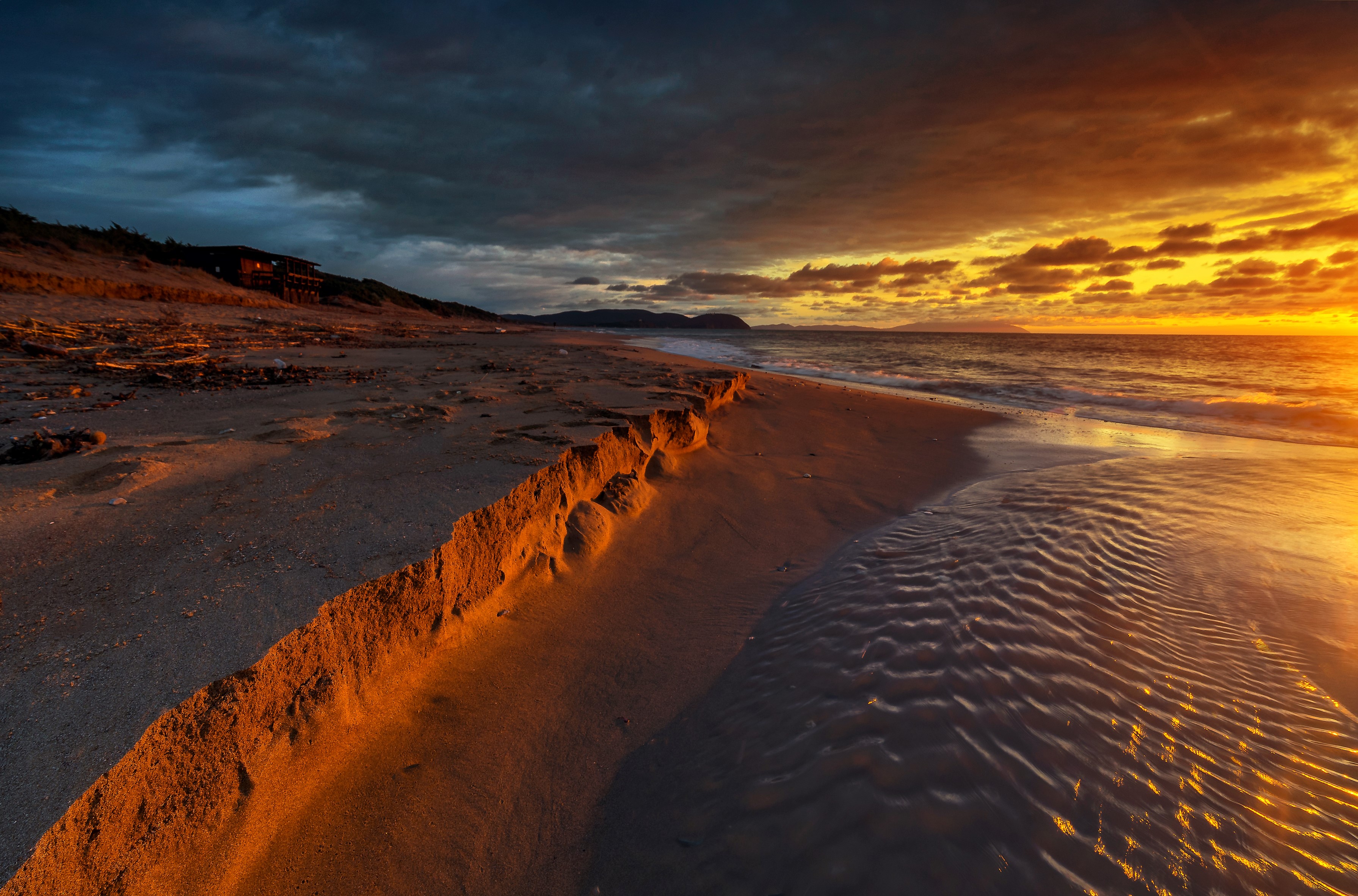Beach at sunset with dramatic clouds HD Wallpaper