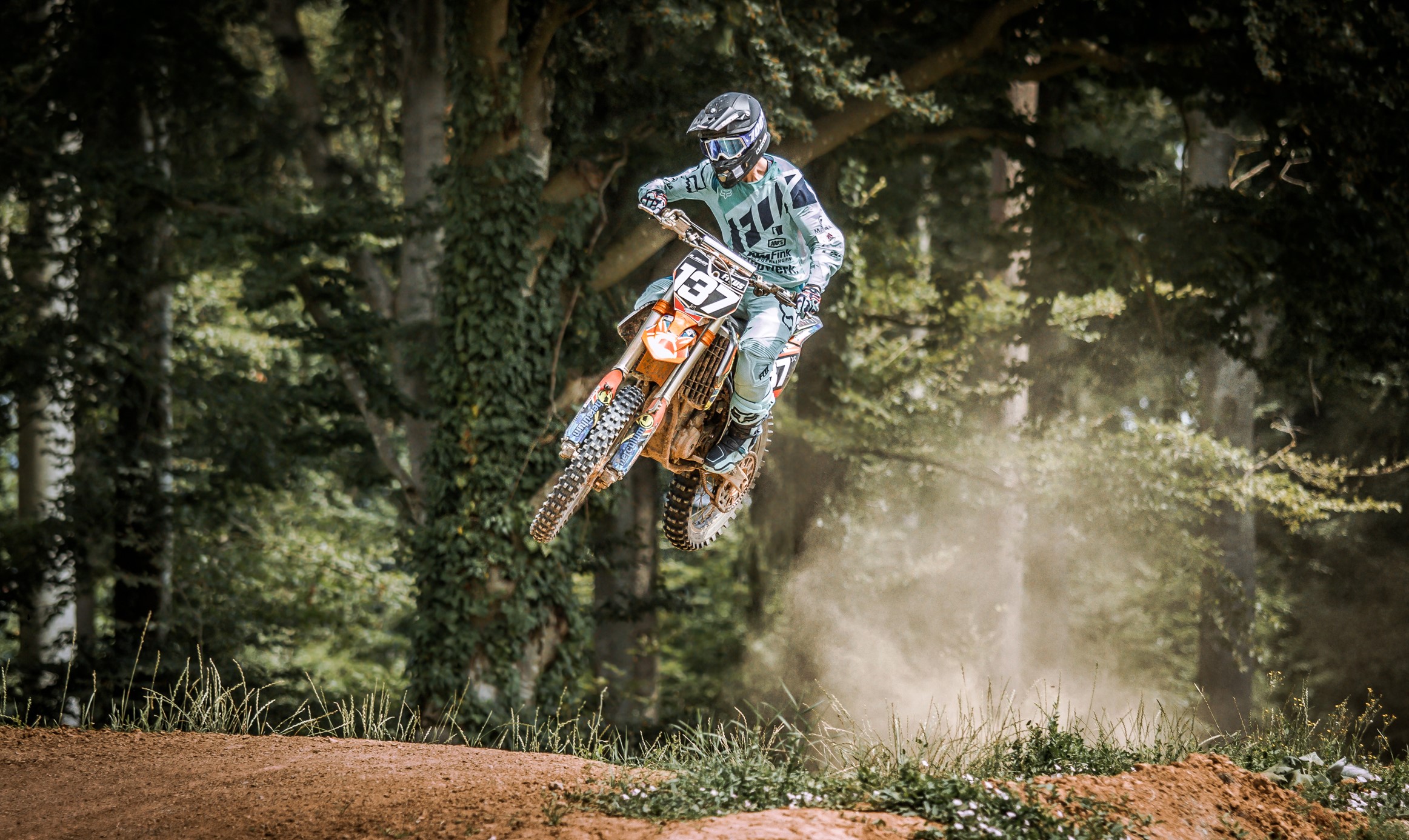 Motocross rider in mid-air jump HD Wallpaper