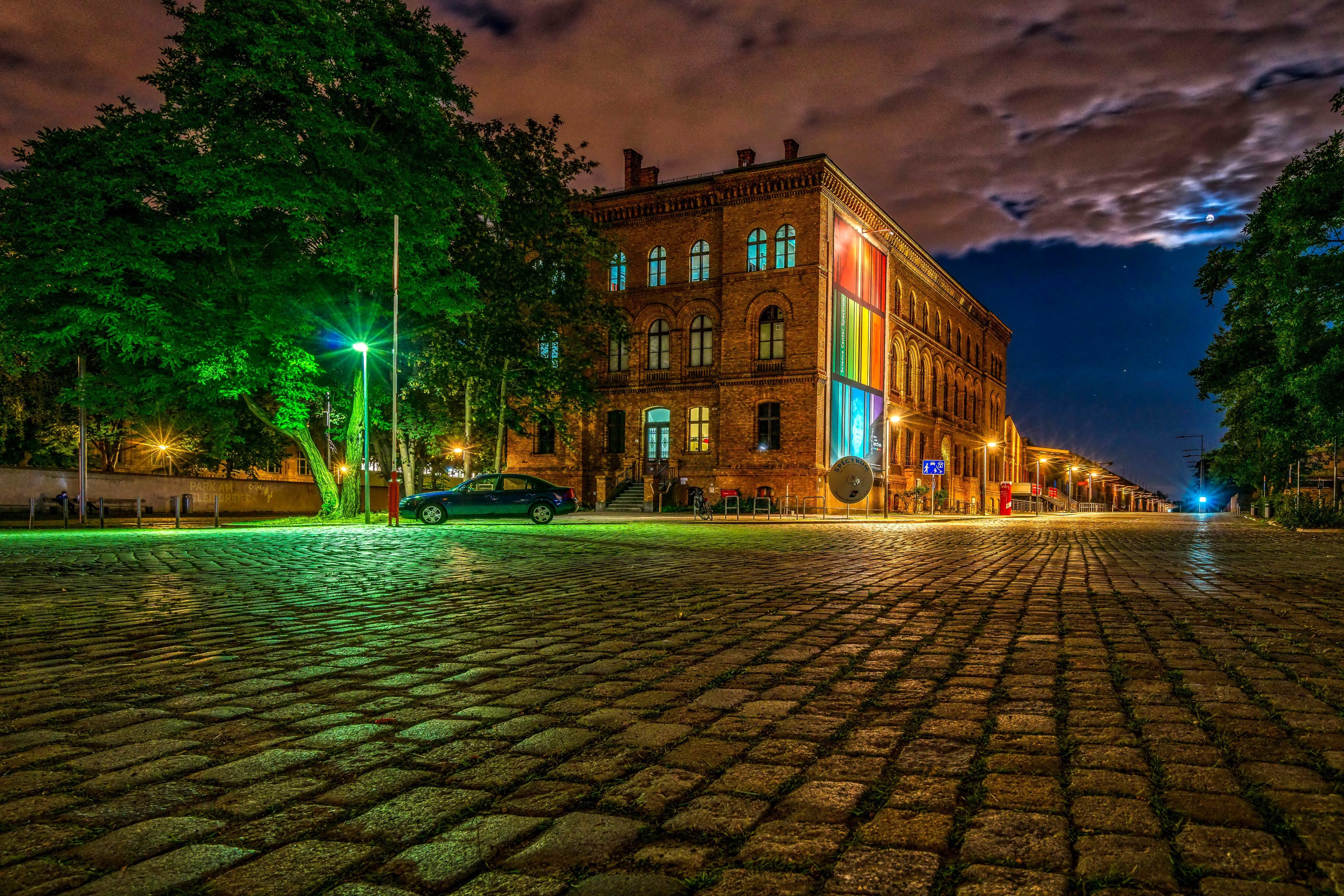 Brick building with rainbow art at night in Berlin HD Wallpaper