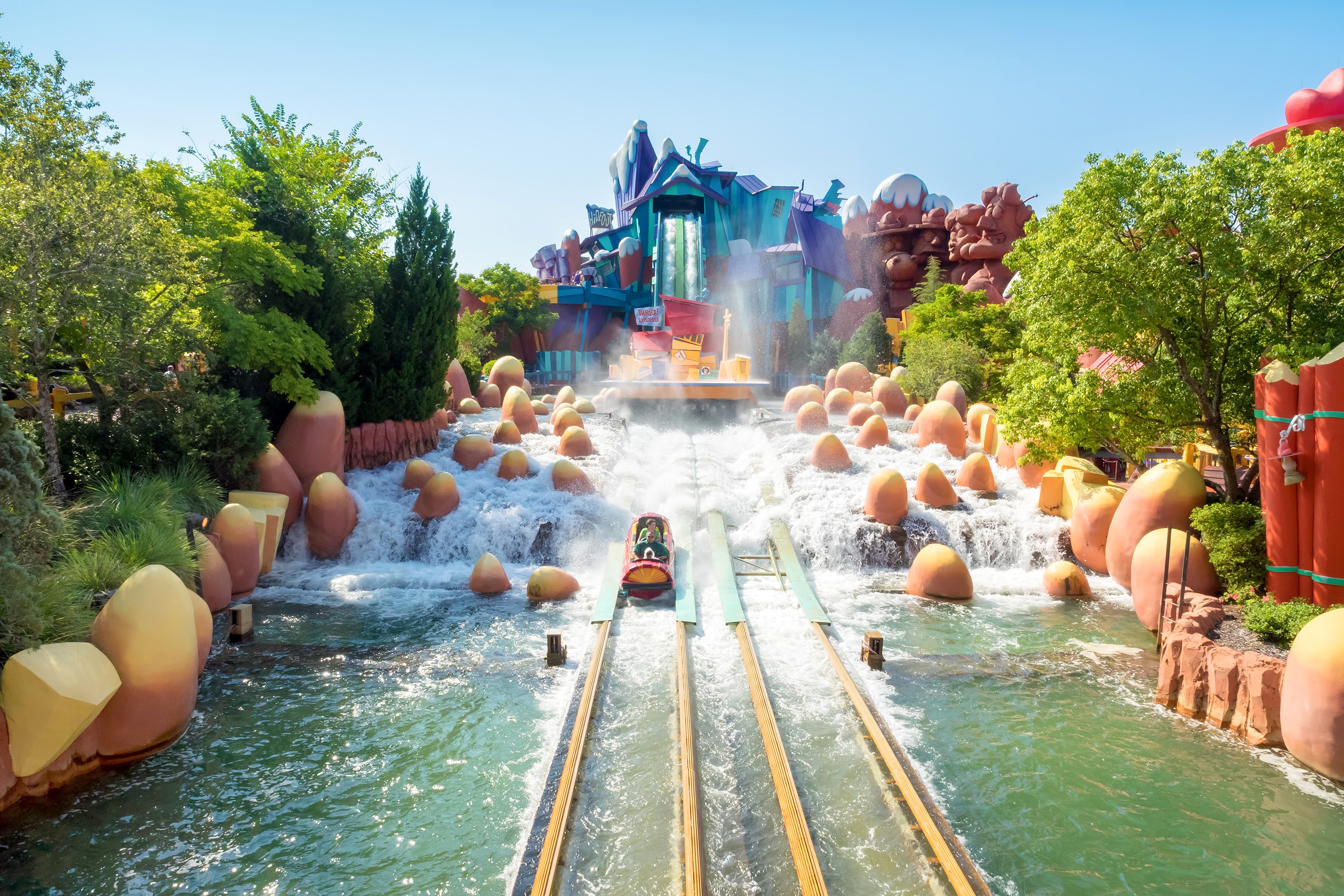 Theme park water ride with colorful structures and a raft HD Wallpaper
