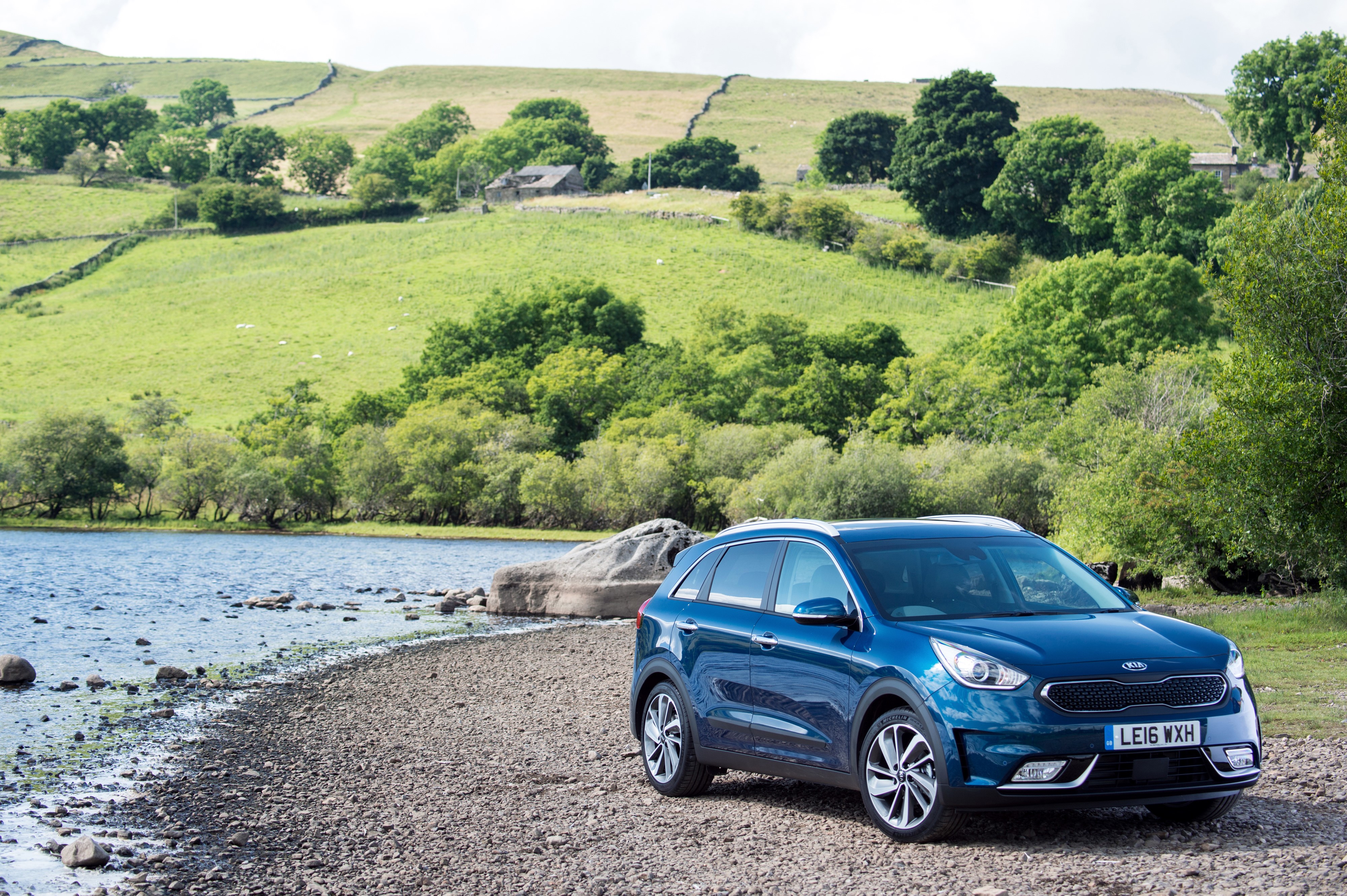 Blue 2016 Kia Niro First Edition by a lake HD Wallpaper