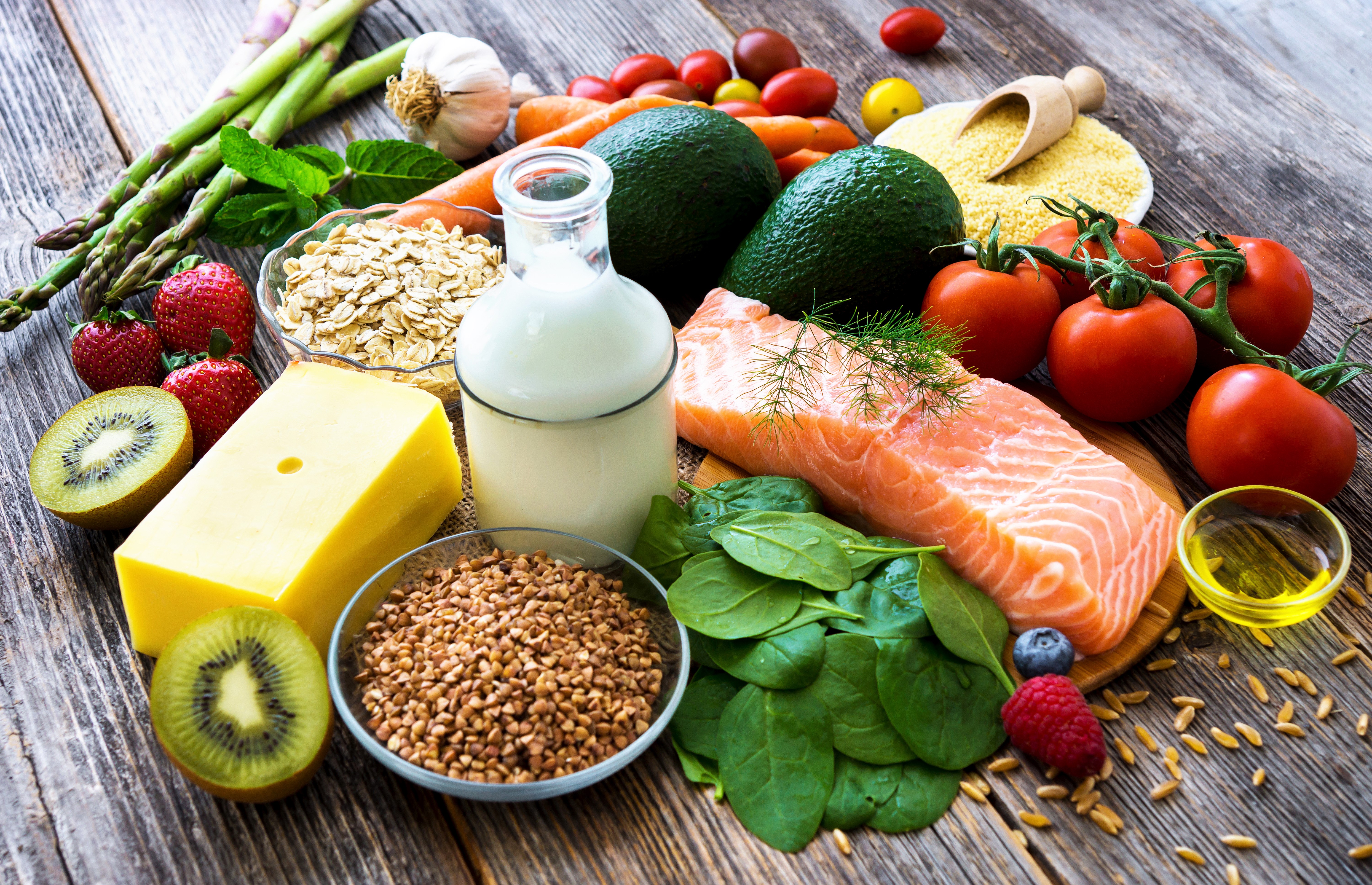 Still life of healthy foods including salmon, vegetables, fruits, and dairy HD Wallpaper