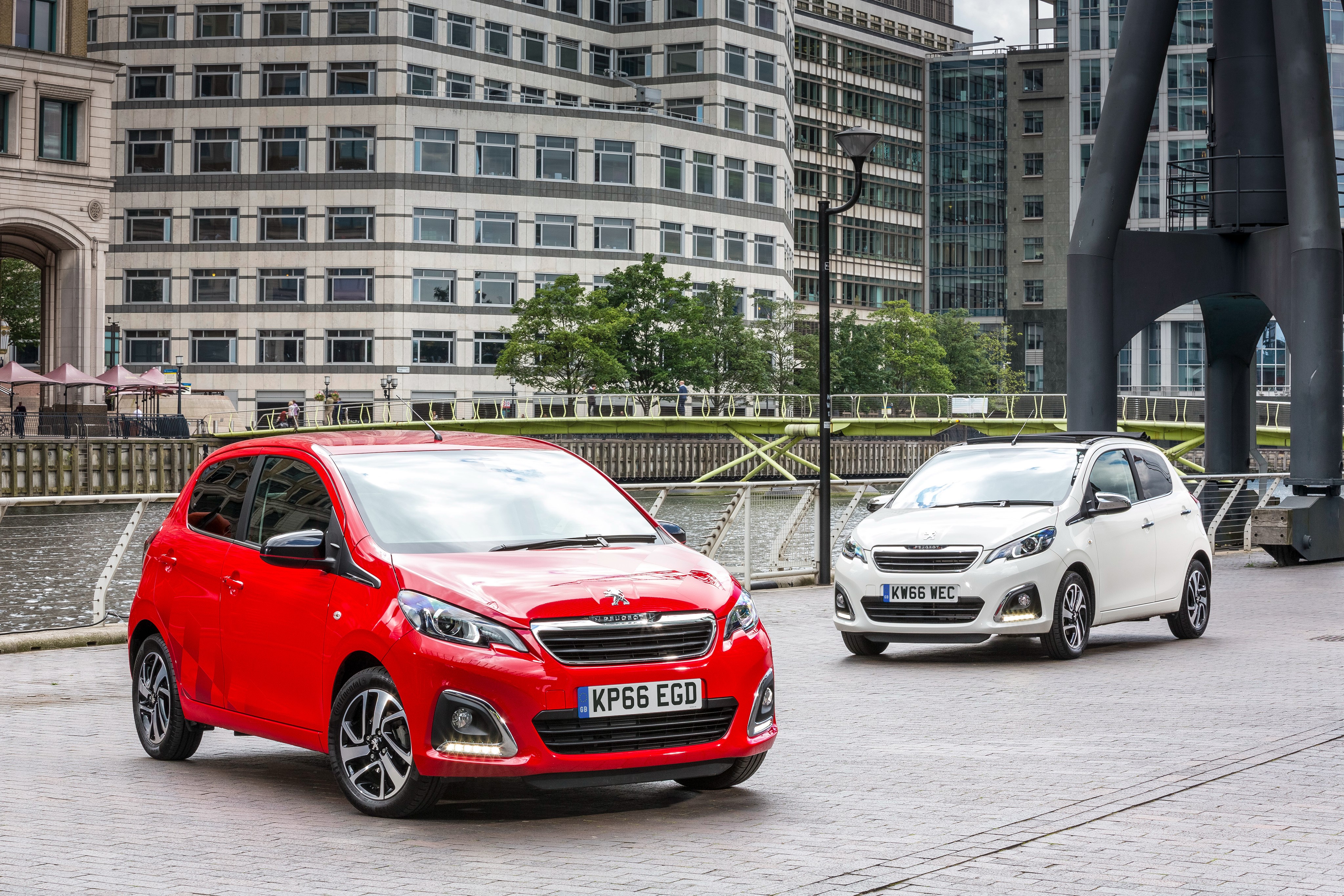 Two Peugeot 108 cars in a city HD Wallpaper
