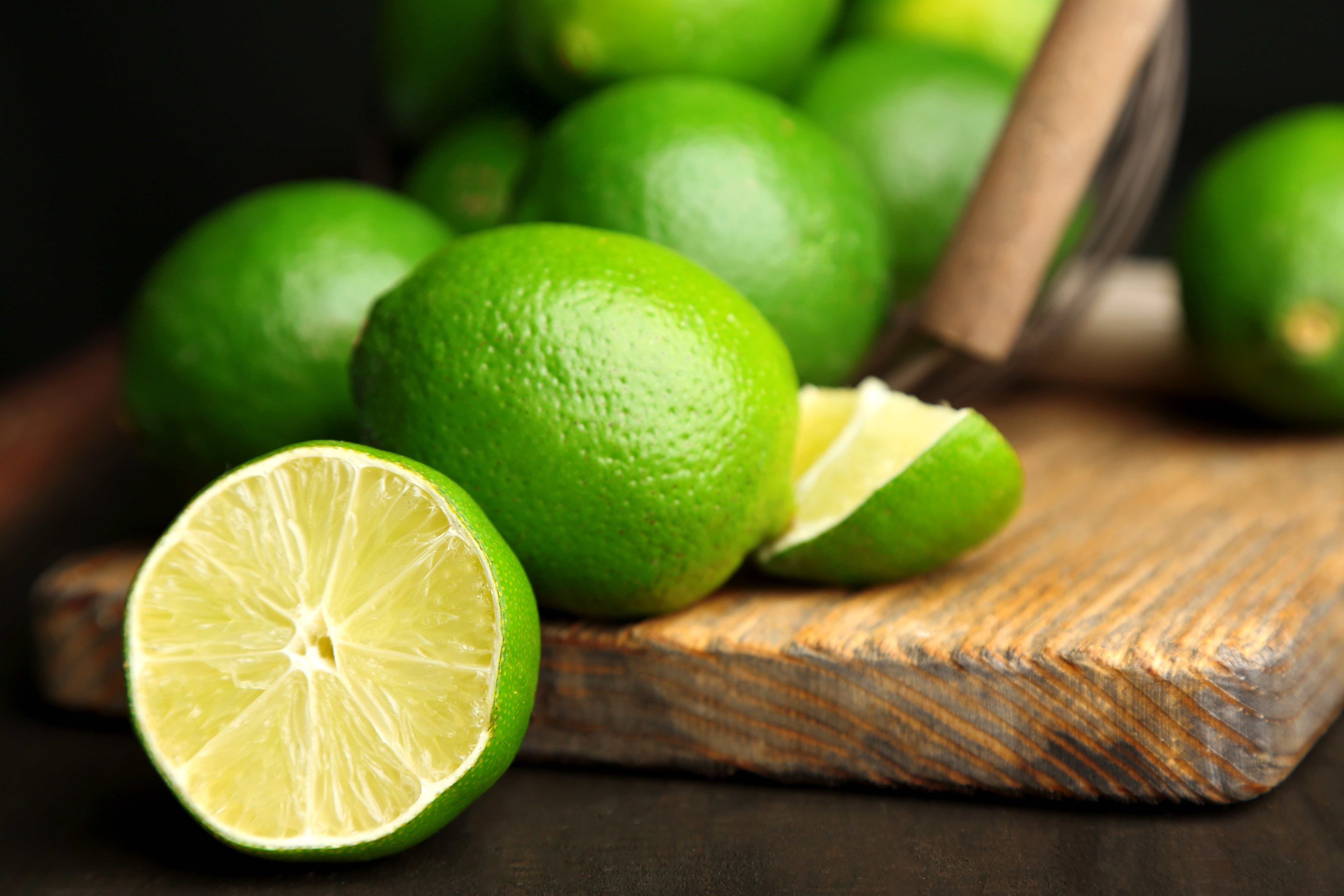 Limes on a Wooden Cutting Board HD Wallpaper