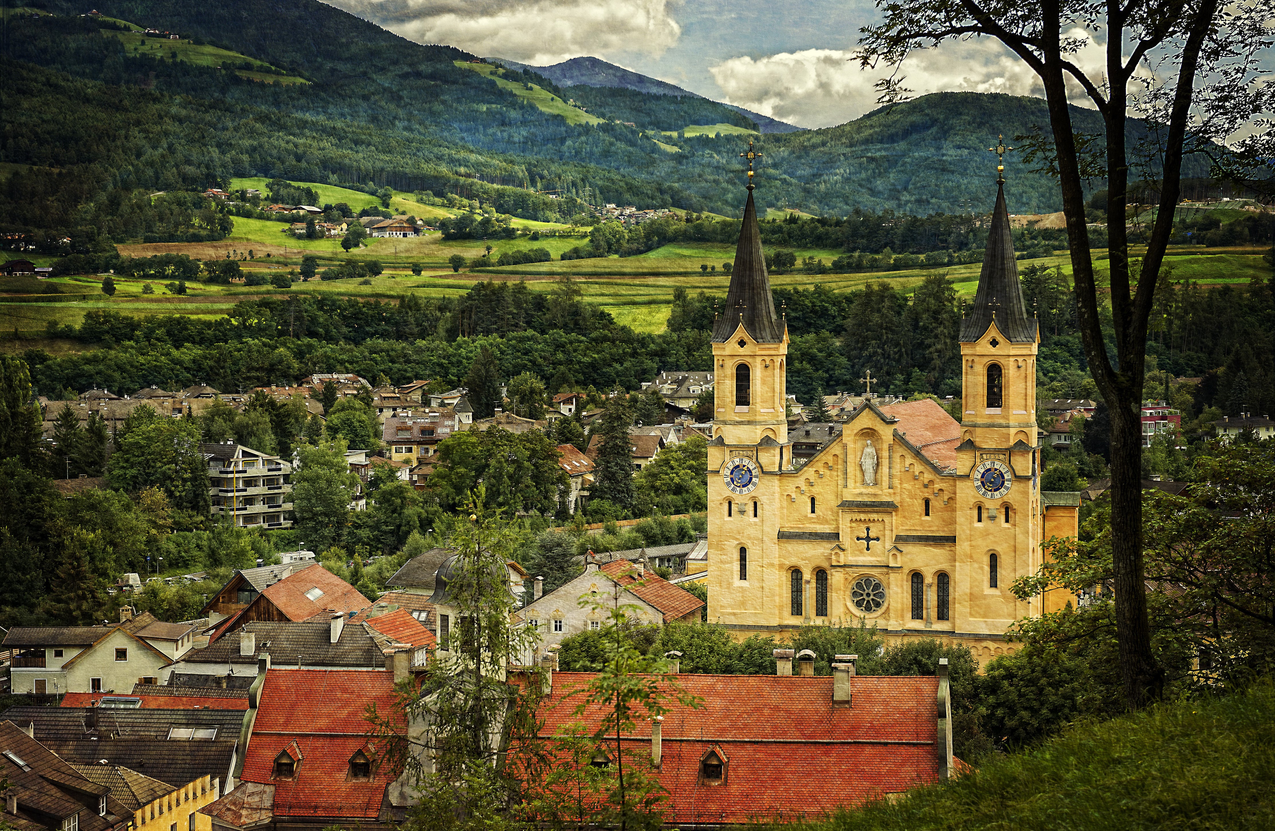 4K Church in Brunico, Italy with Mountains and Forests HD Wallpaper