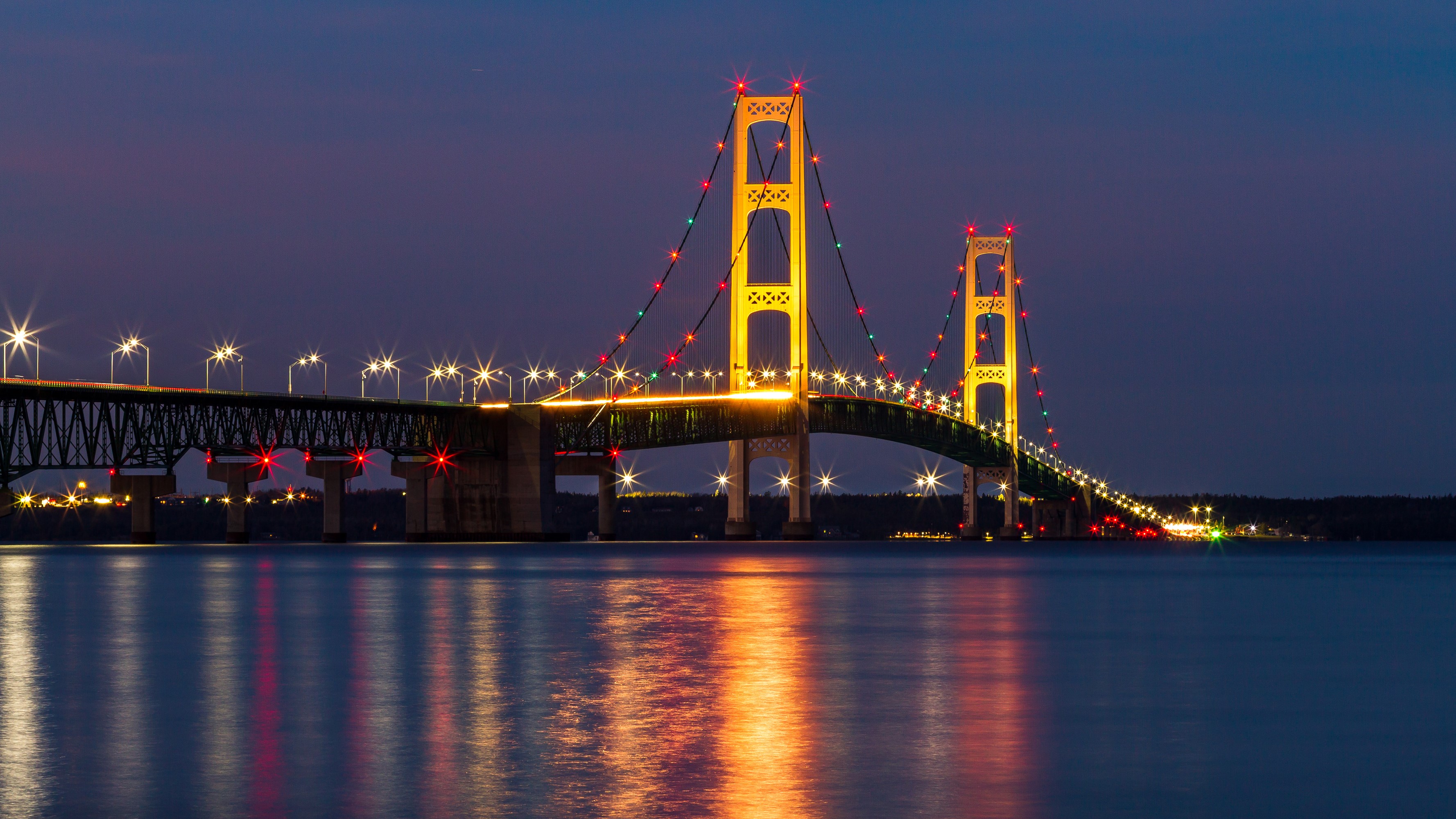 Mackinac Bridge at night with colorful lights HD Wallpaper