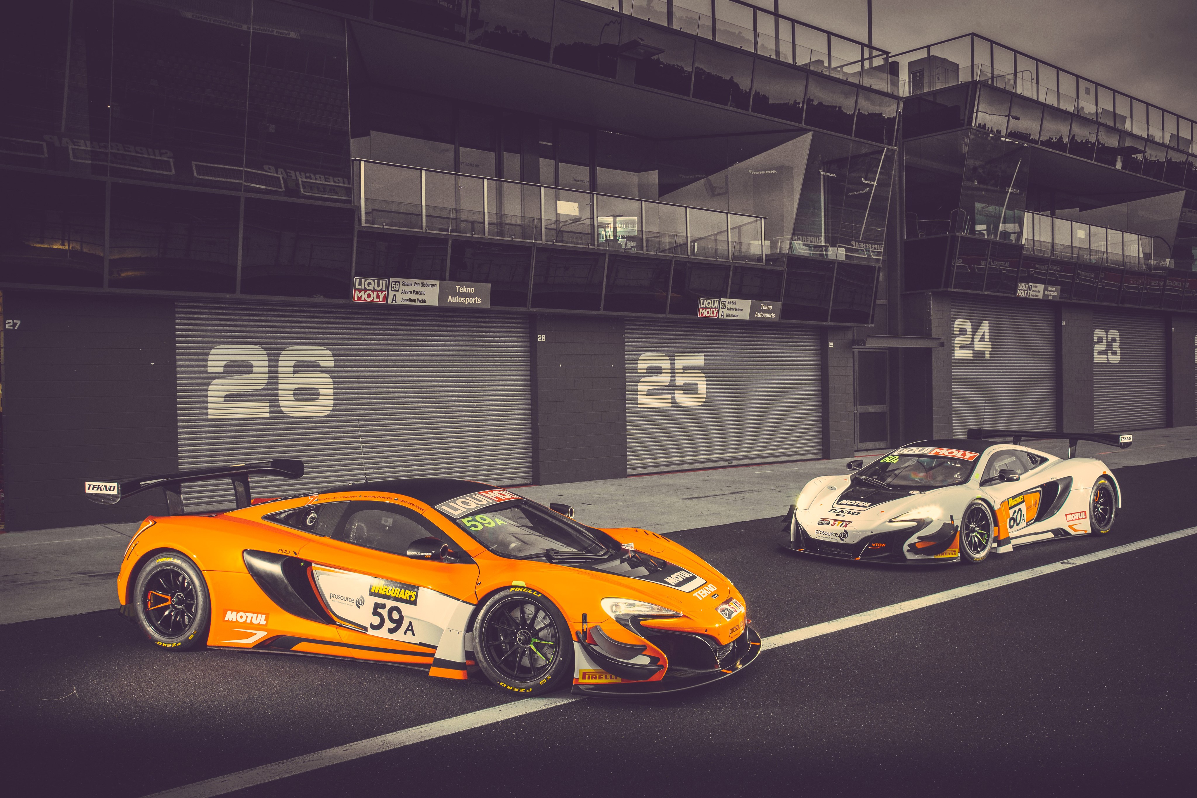 Two McLaren 650S GT3 race cars at pit lane HD Wallpaper