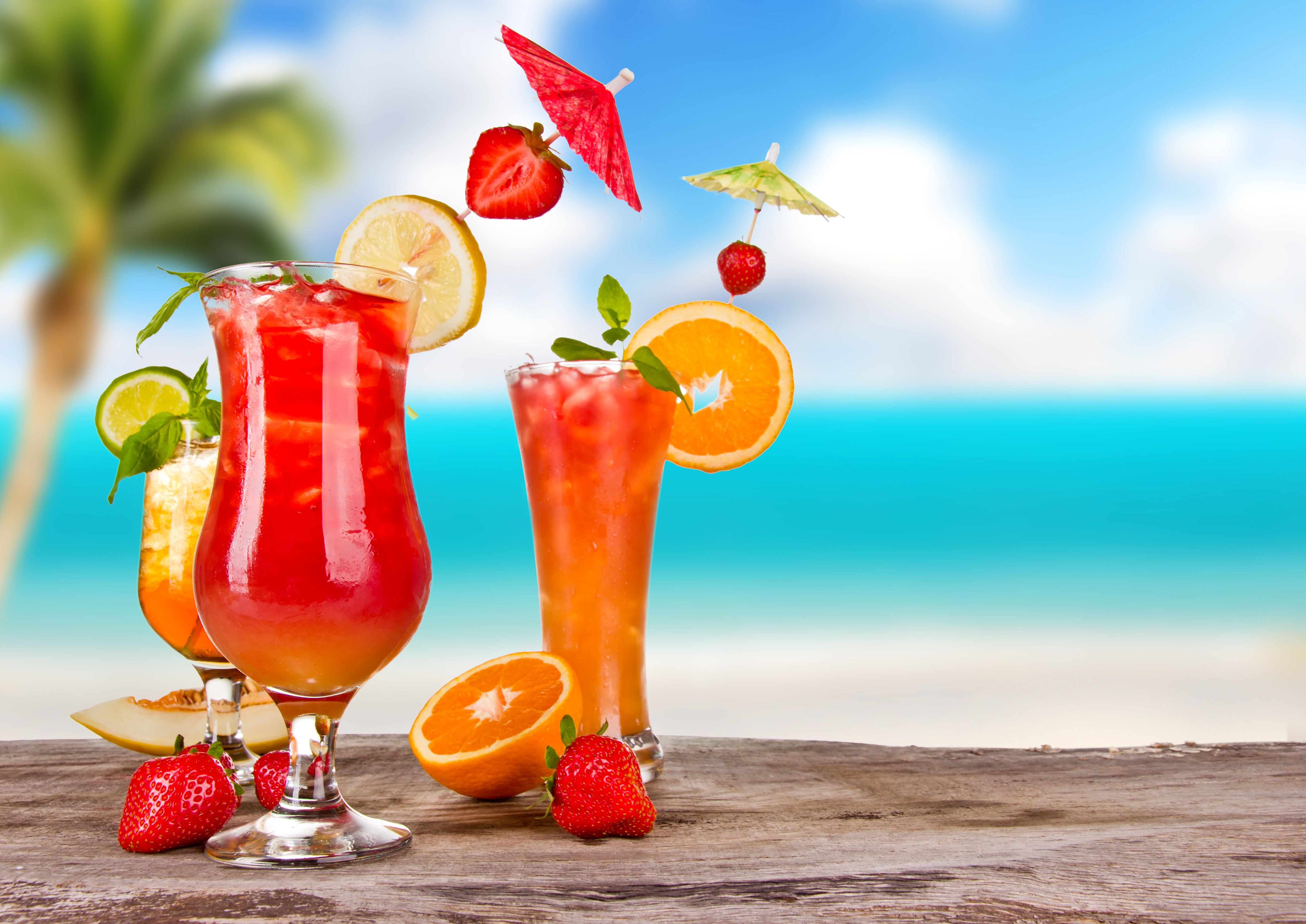 Tropical Cocktails with Fruit and Beach Background HD Wallpaper