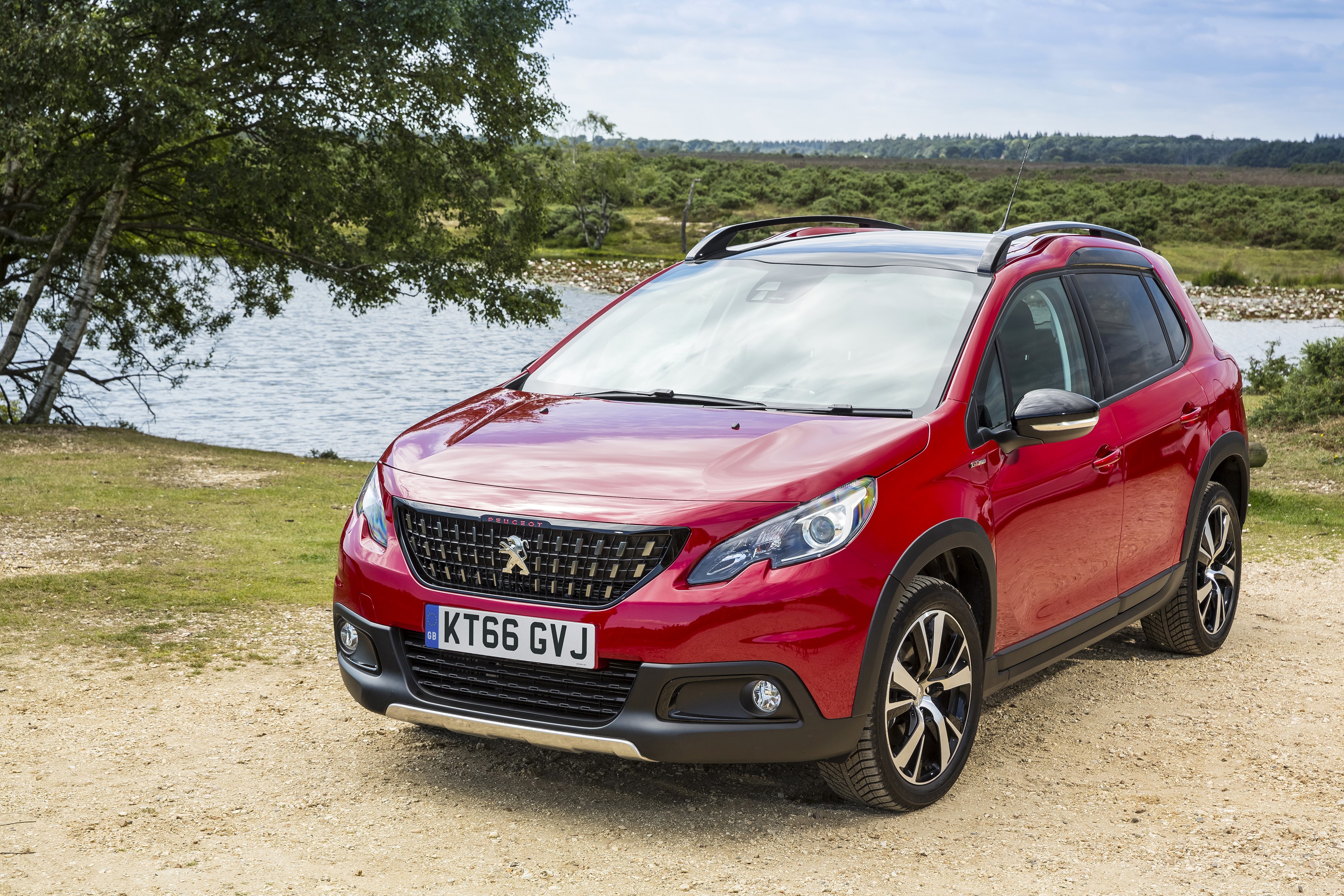 Red Peugeot 2008 GT Line parked by a lake HD Wallpaper