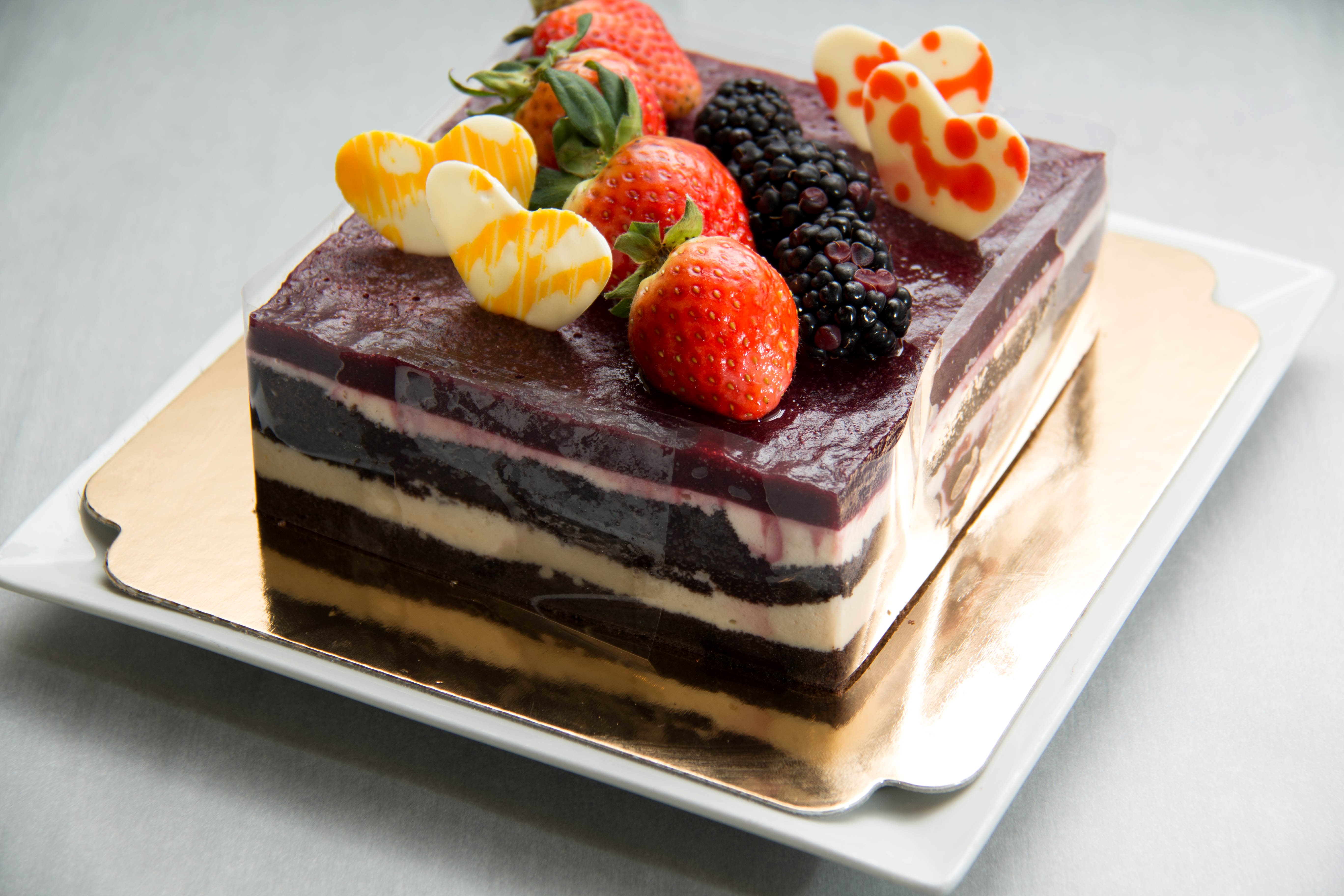 Layered berry cake with fresh fruit and chocolate decorations HD Wallpaper