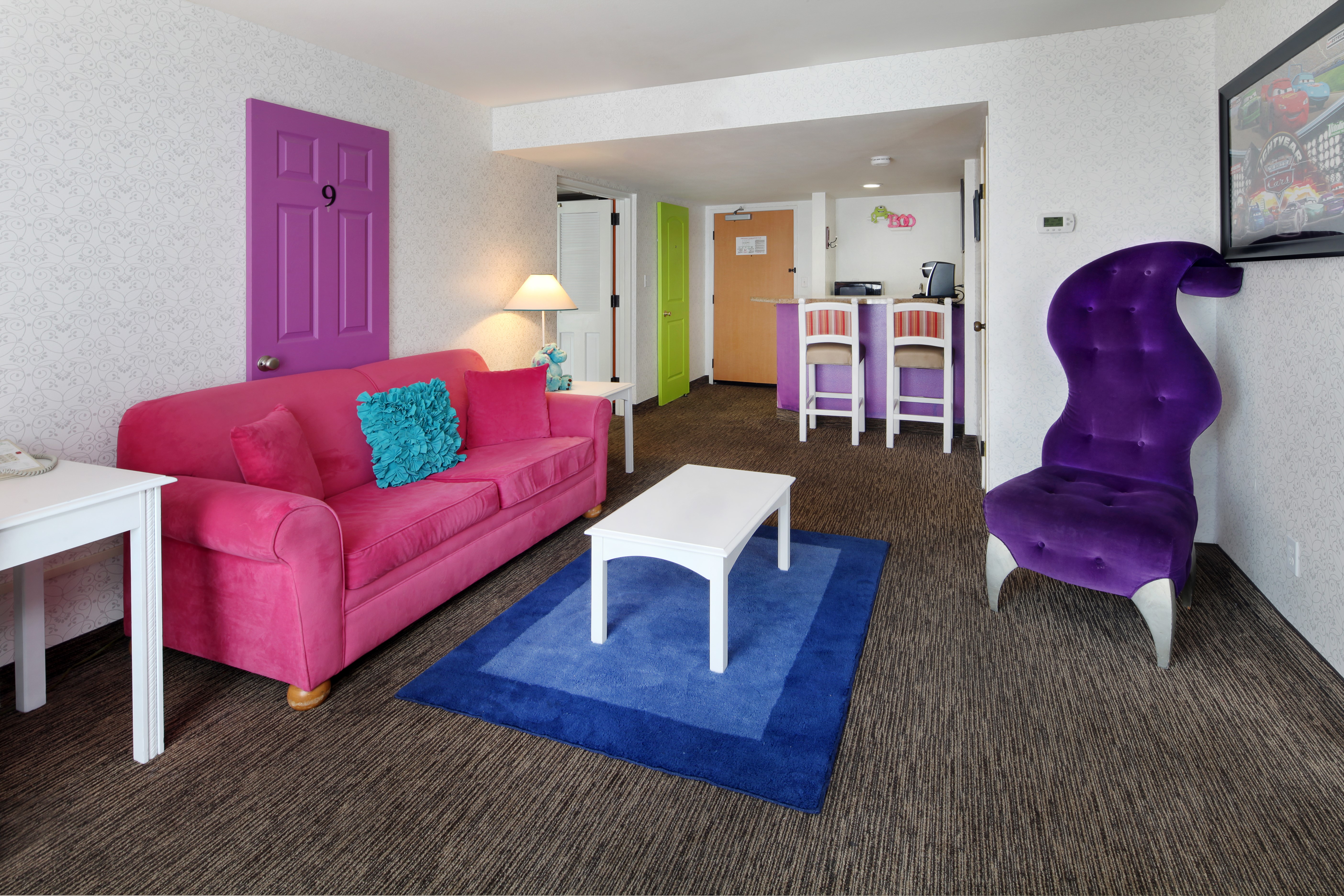 Living room with pink sofa and purple chair HD Wallpaper