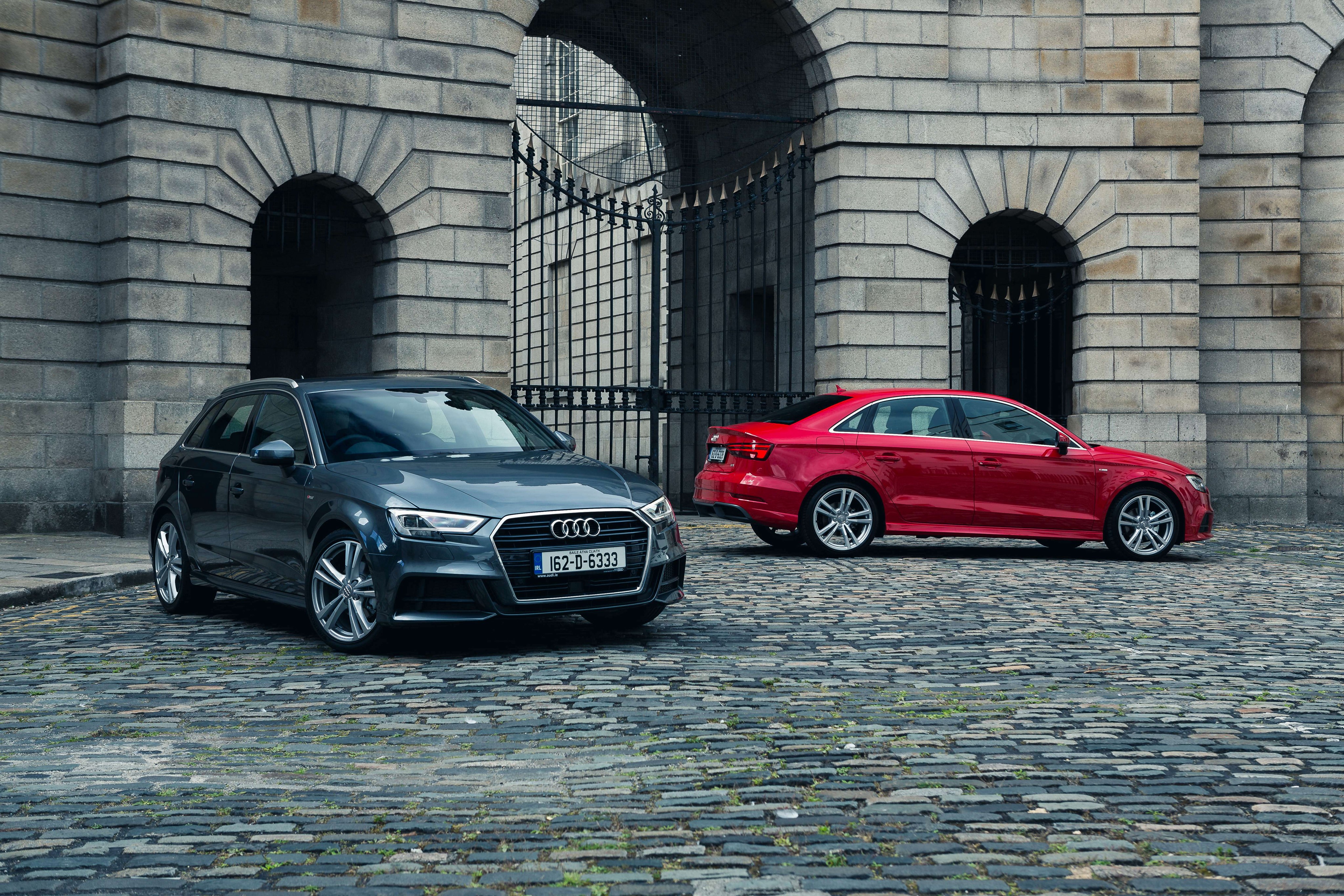 Two Audi A3 cars parked outside a stone building HD Wallpaper