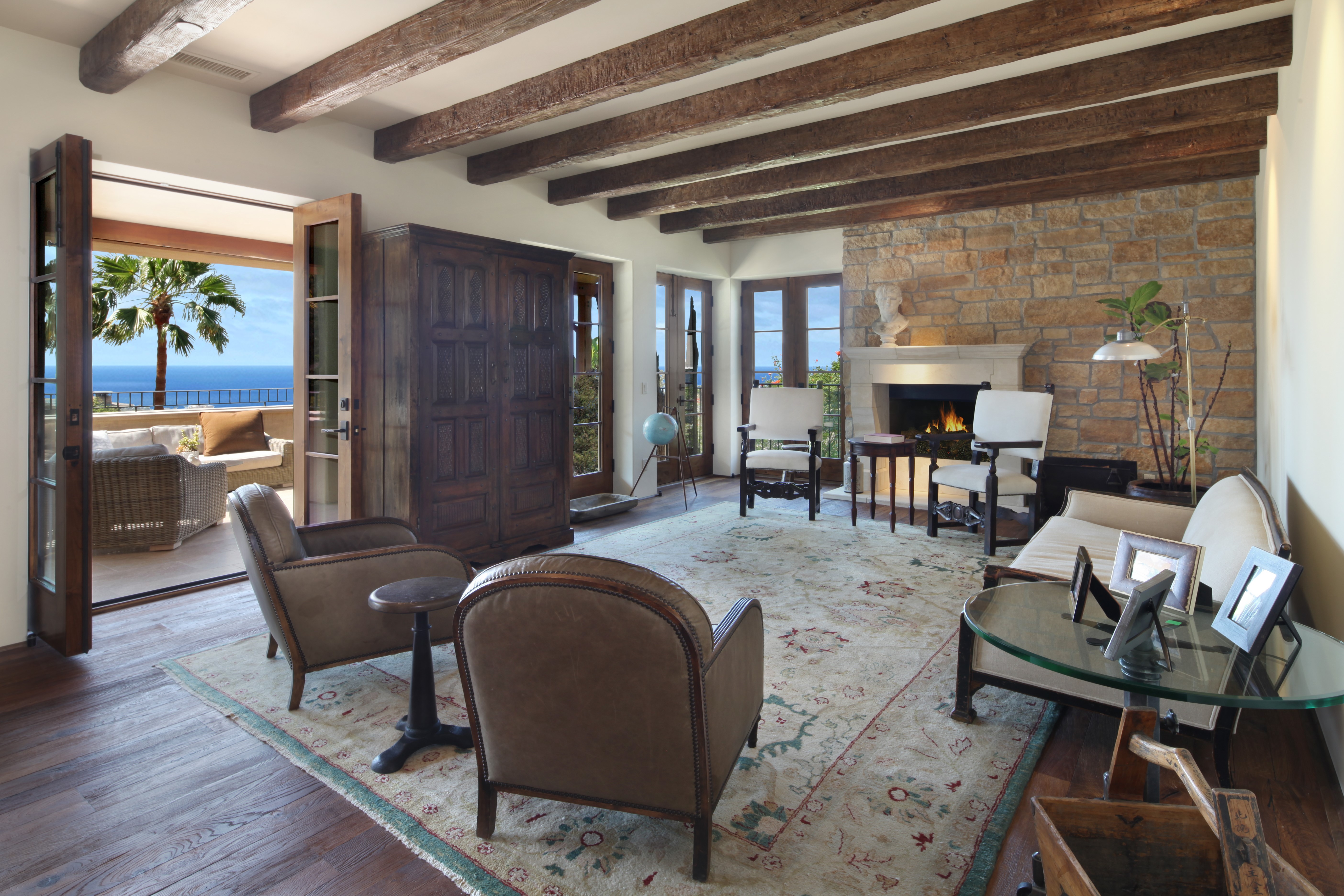 Living room with ocean view and fireplace HD Wallpaper
