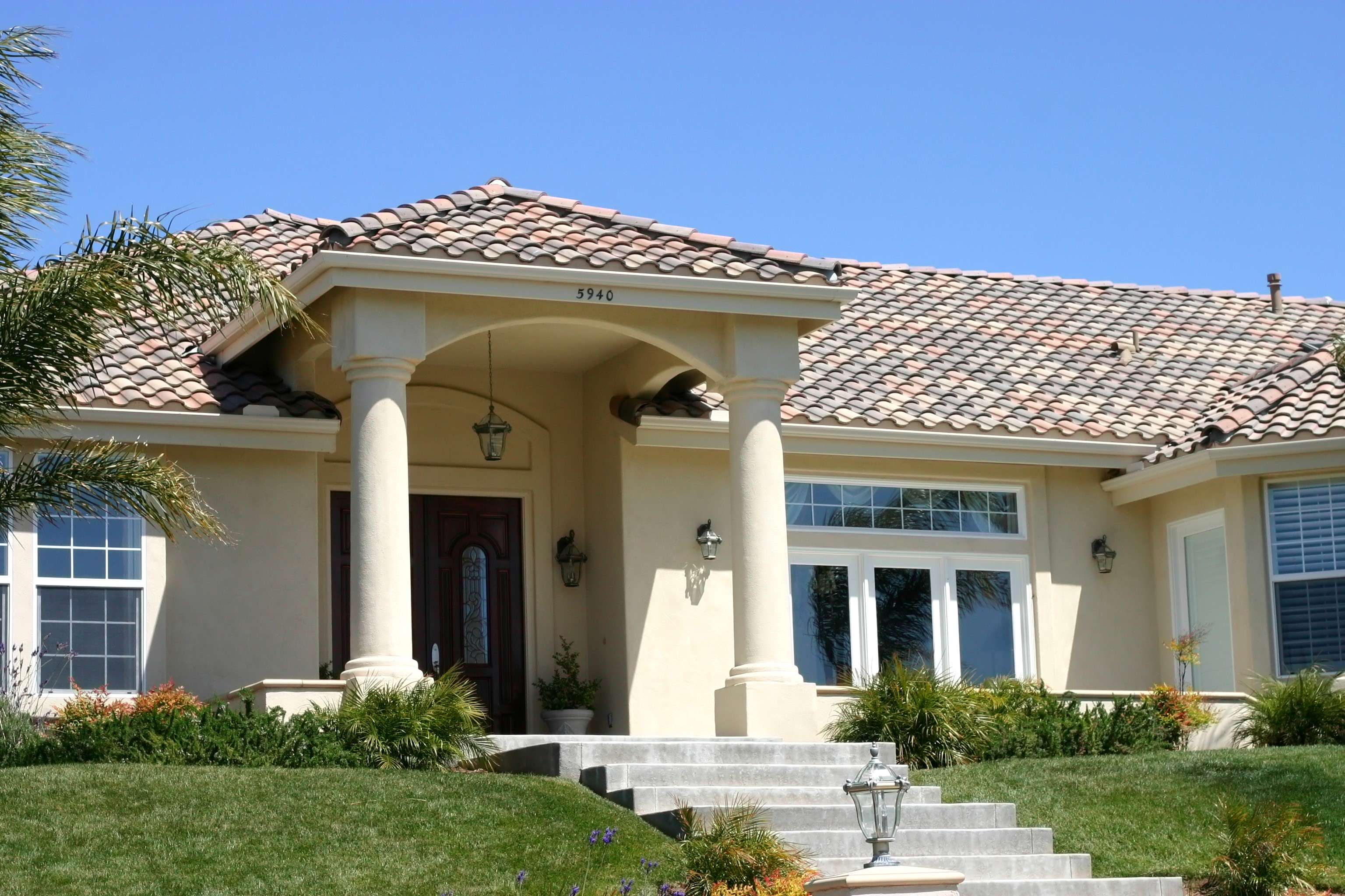 Luxury house with tiled roof and grand entrance HD Wallpaper