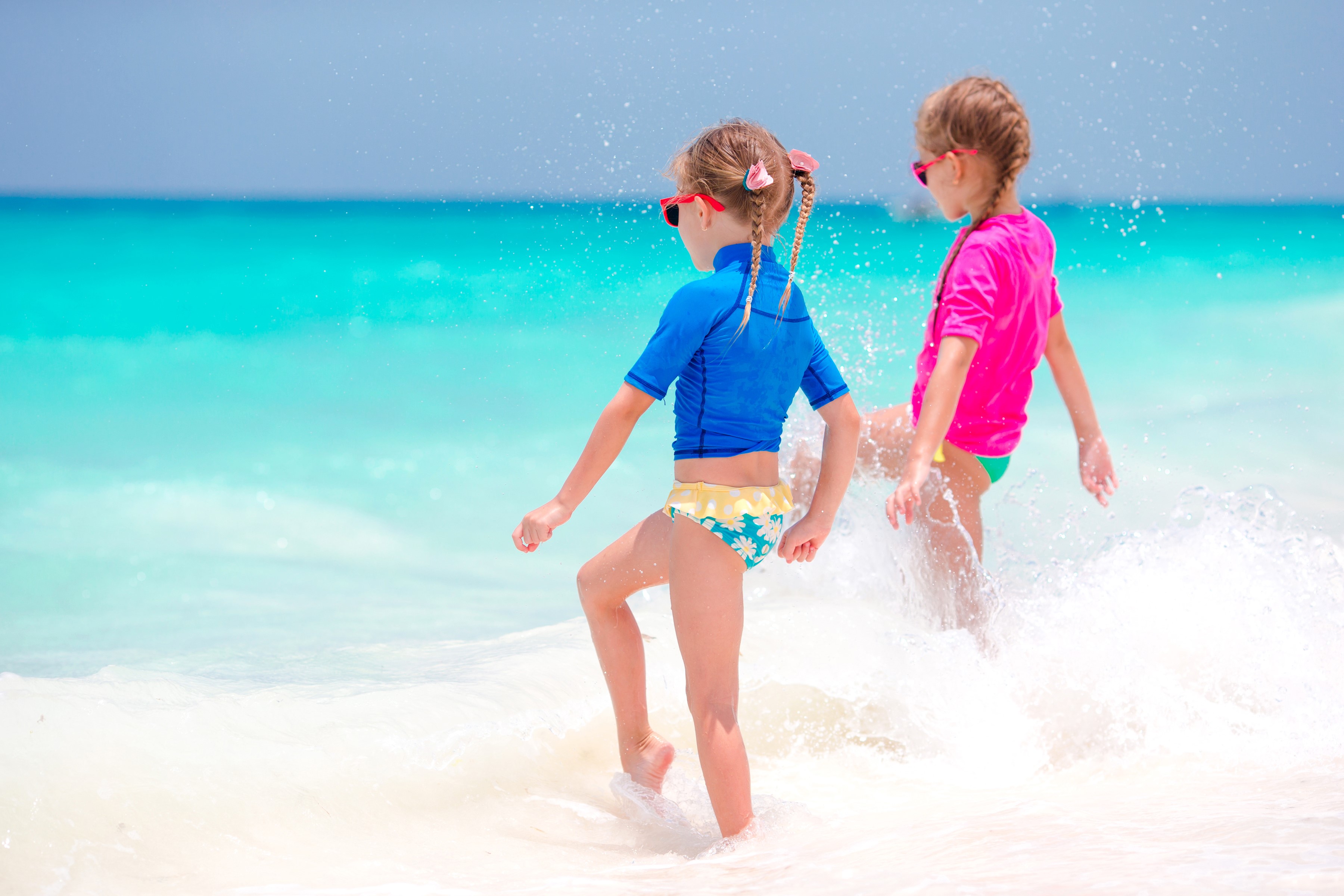 Two little girls in swimsuits at the sea HD Wallpaper