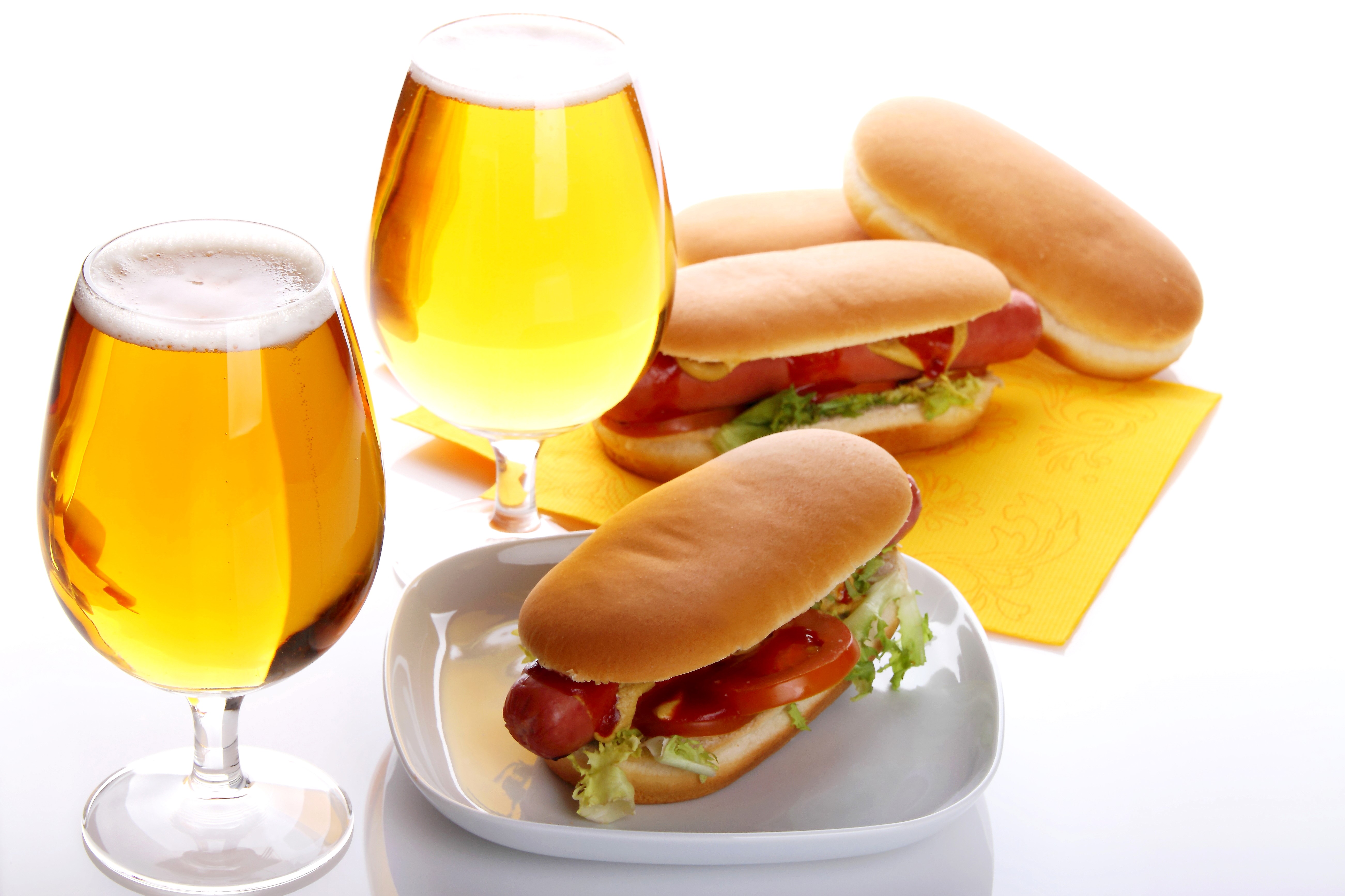 Two glasses of beer and hot dogs on a white background HD Wallpaper