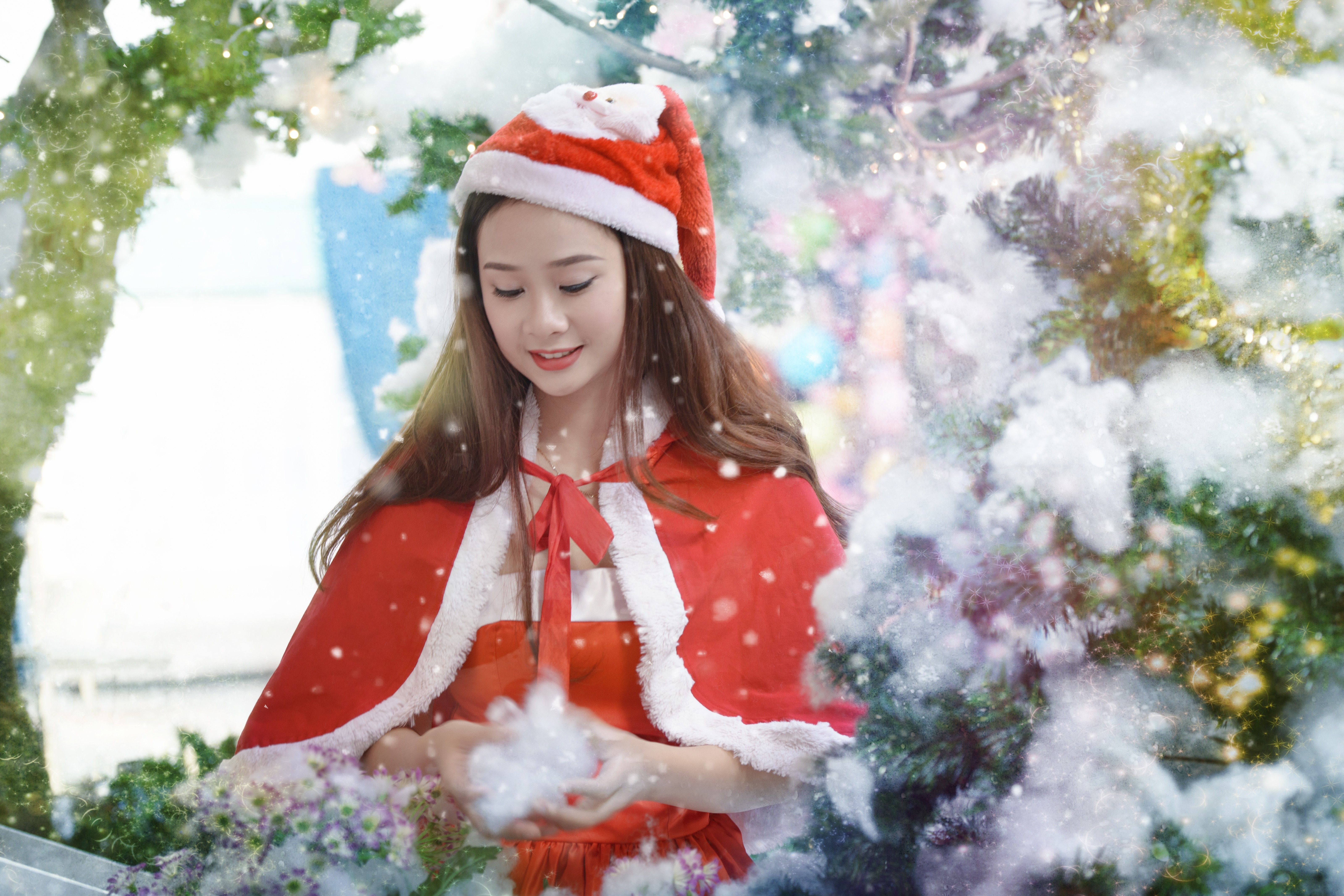 Asian woman in Santa costume with snow HD Wallpaper