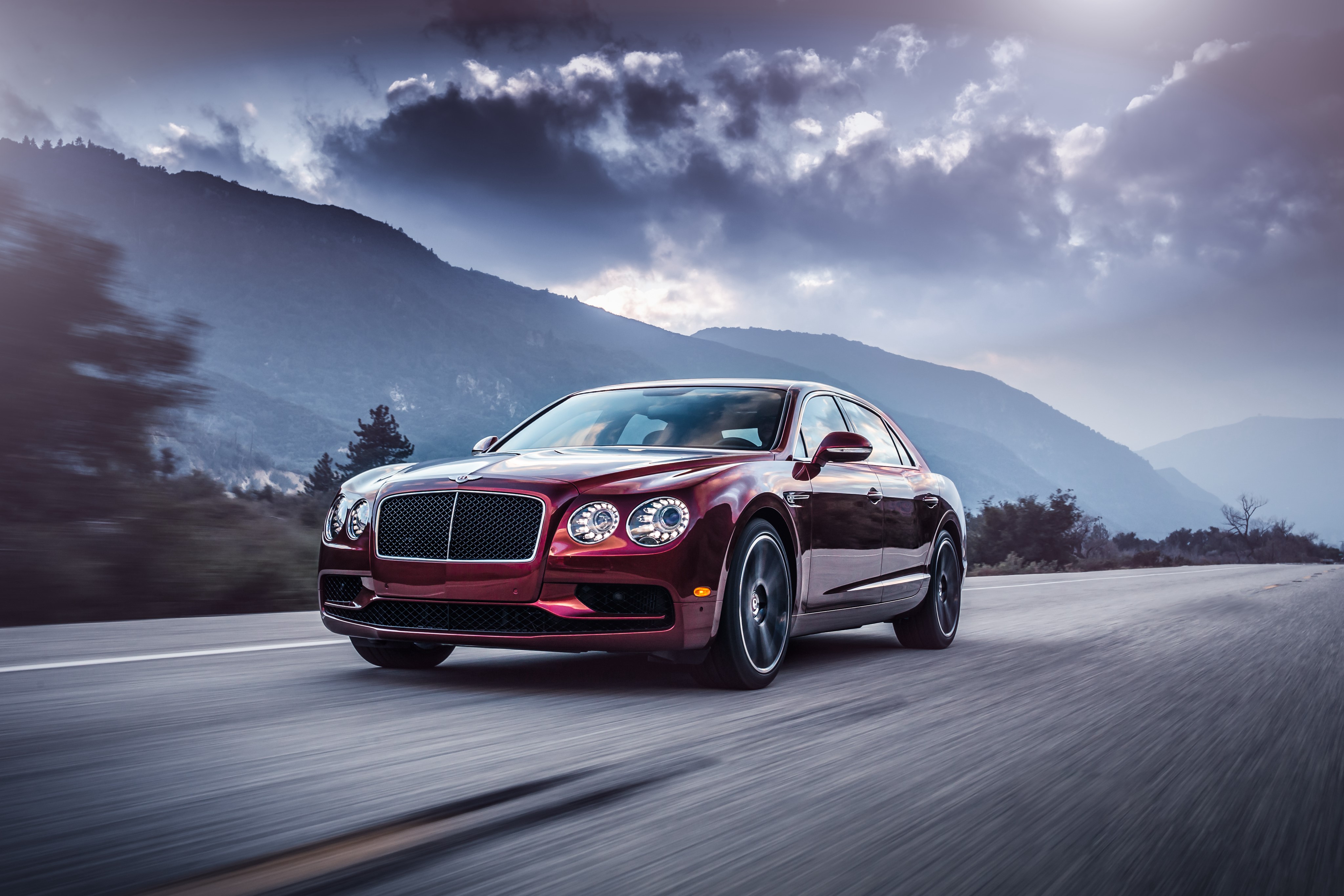 Bentley Flying Spur in motion on a mountain road HD Wallpaper