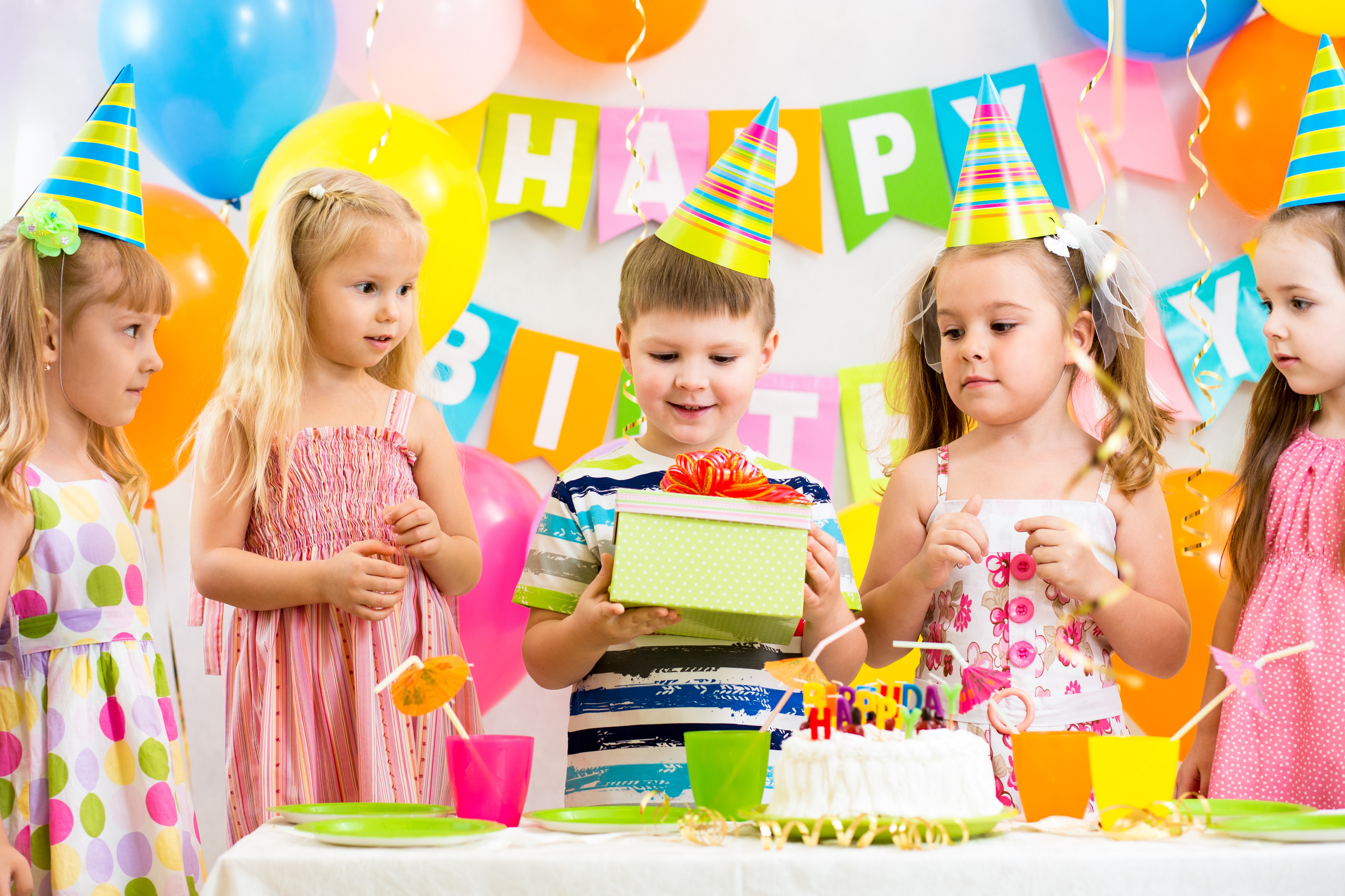 Children celebrating a birthday with cake and gifts HD Wallpaper