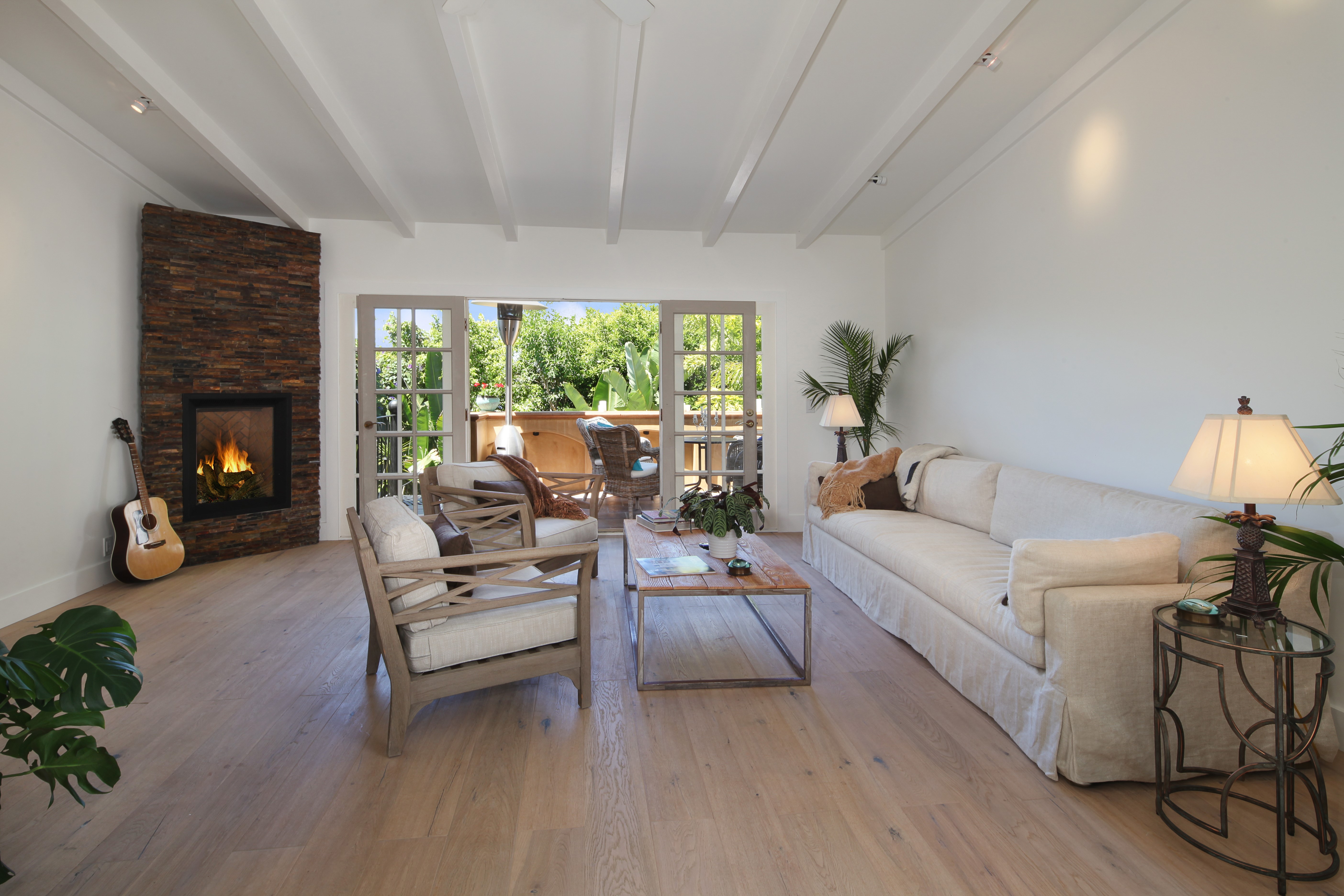 Living room with fireplace, sofa, and armchair HD Wallpaper