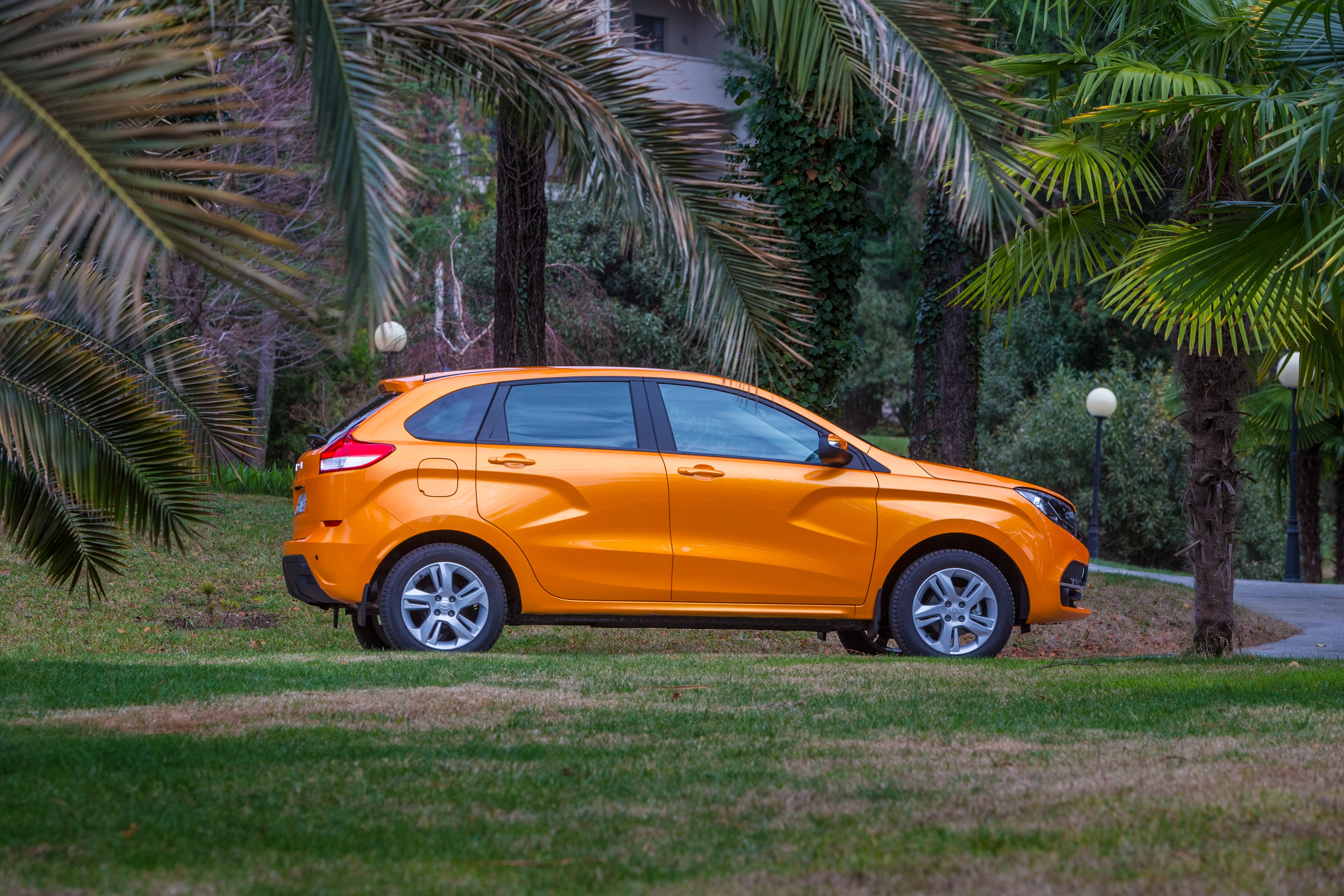 Orange Lada XRAY car parked on grass HD Wallpaper