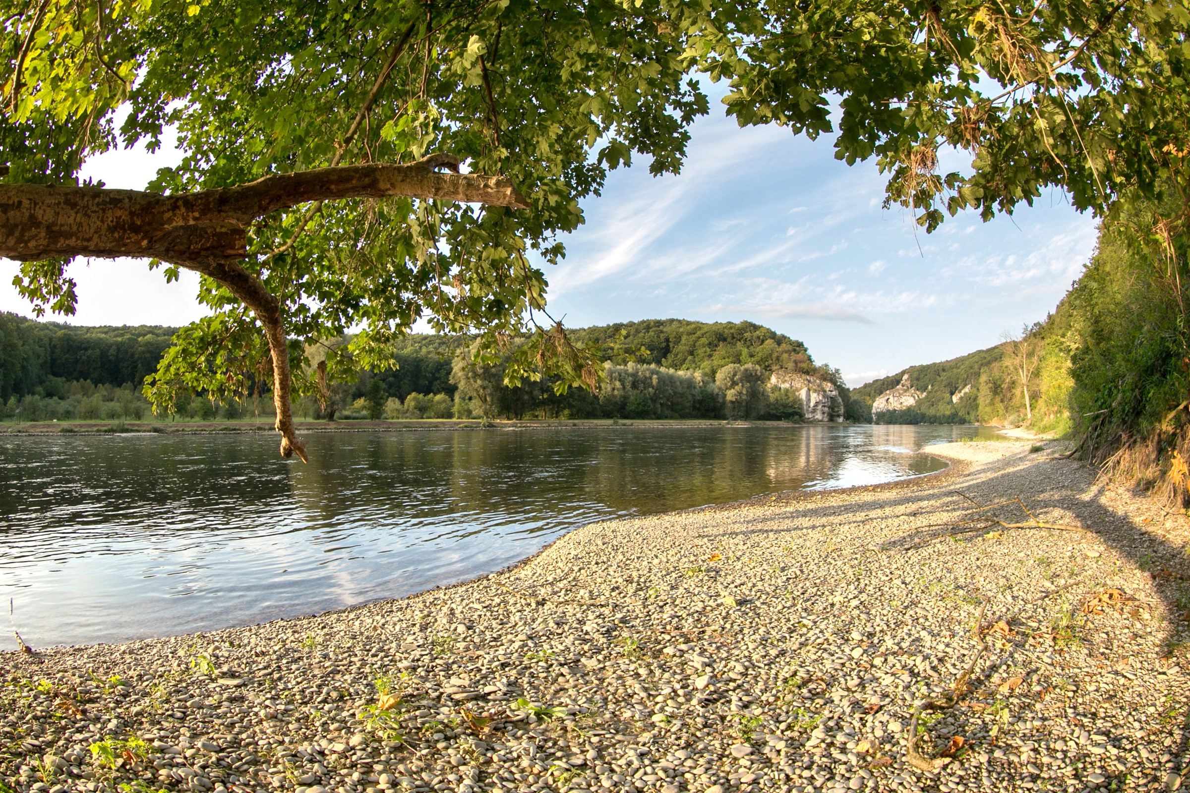 Riverbank with trees and rocky hills in Kelheim, Germany HD Wallpaper