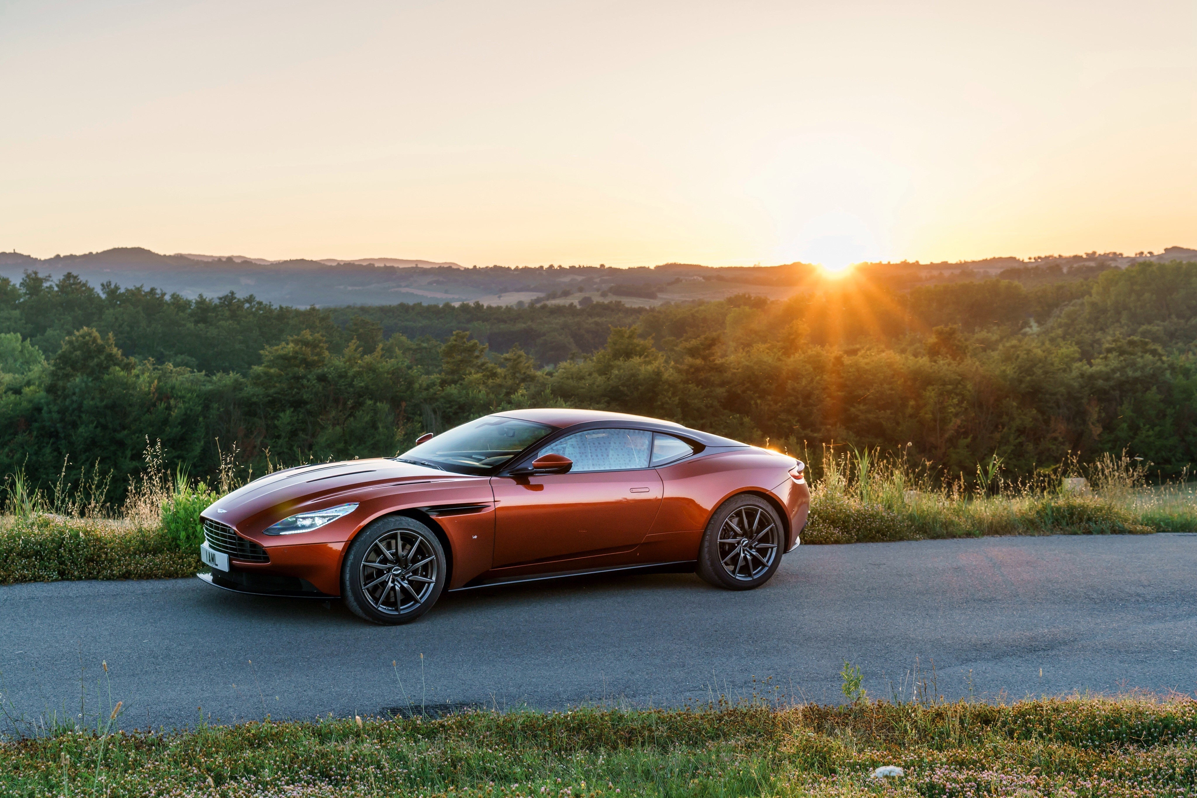 Aston Martin DB11 on a road at sunset HD Wallpaper