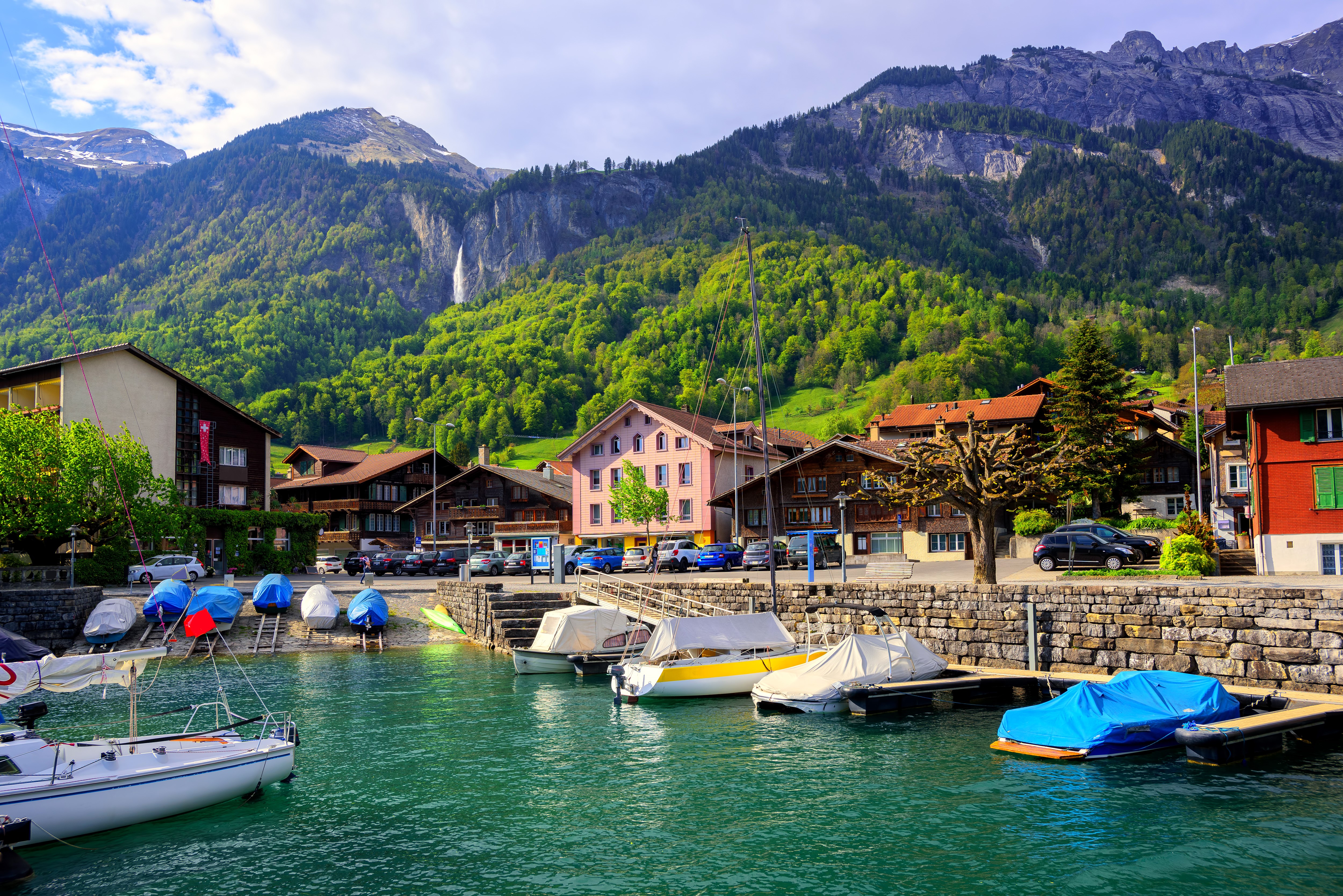 Boats docked on Lake Interlaken, Switzerland with mountains HD Wallpaper