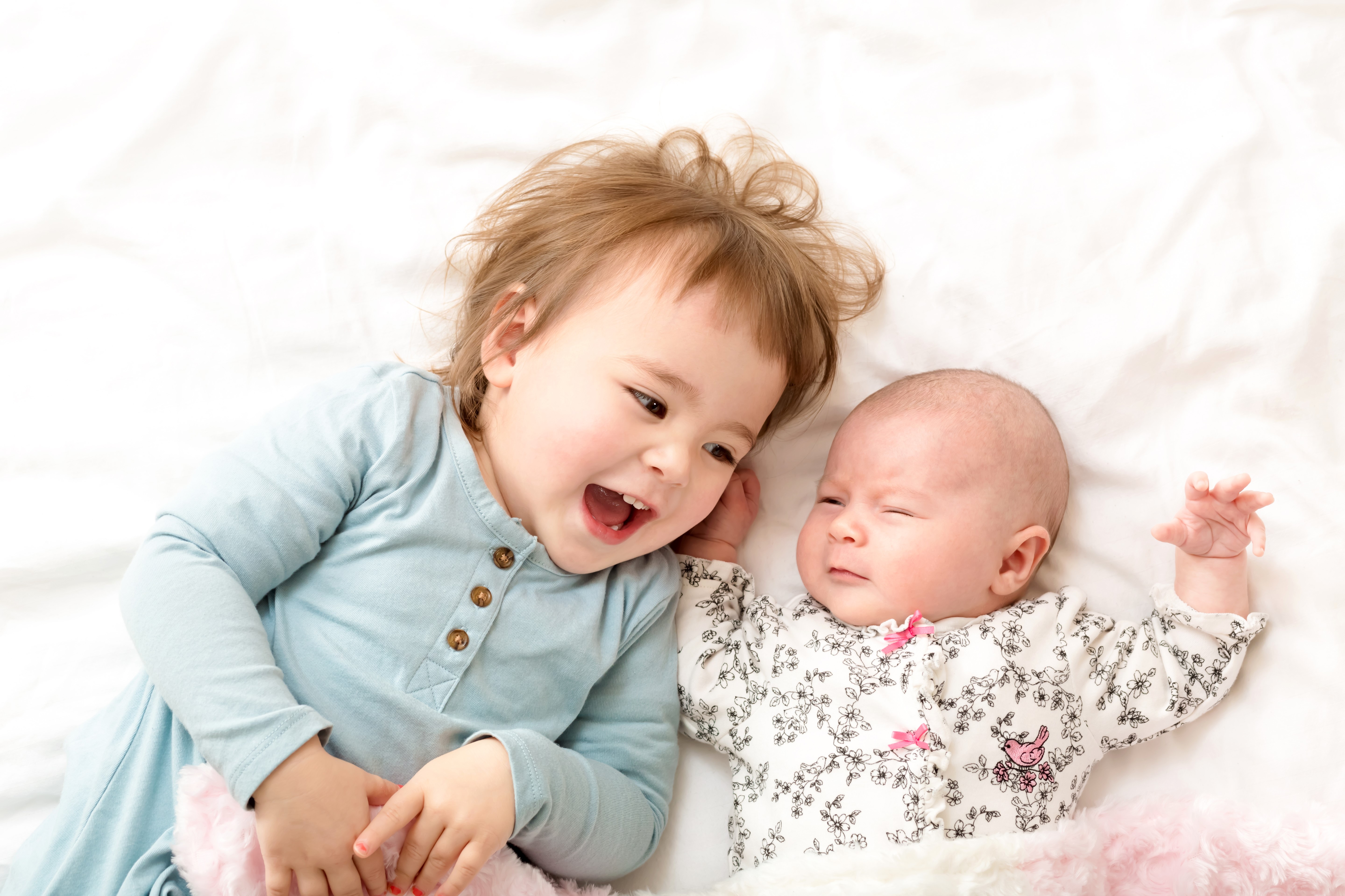 Two little girls, one infant, smiling and laughing HD Wallpaper