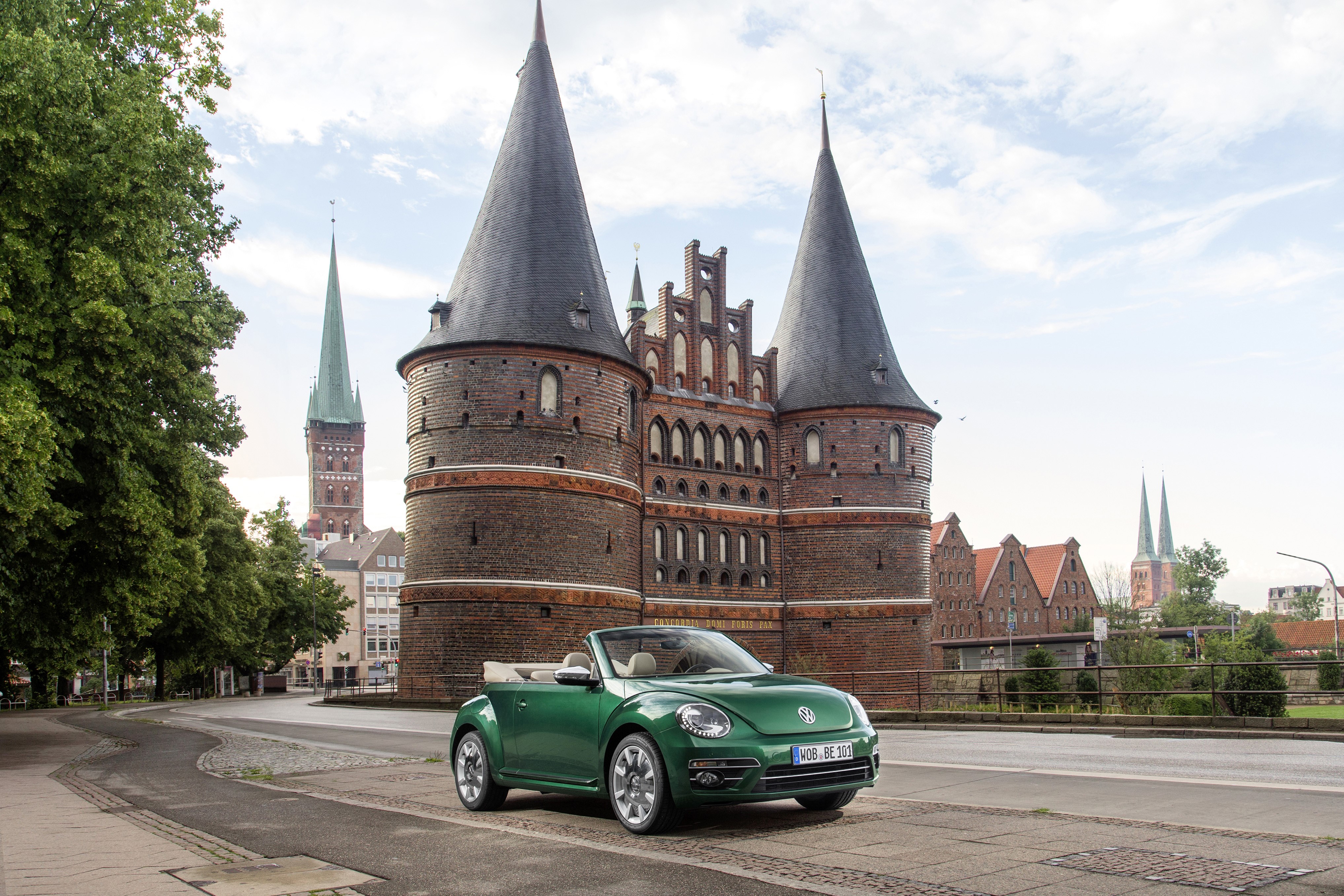 Green Volkswagen Beetle Cabriolet in front of Holsten Gate HD Wallpaper