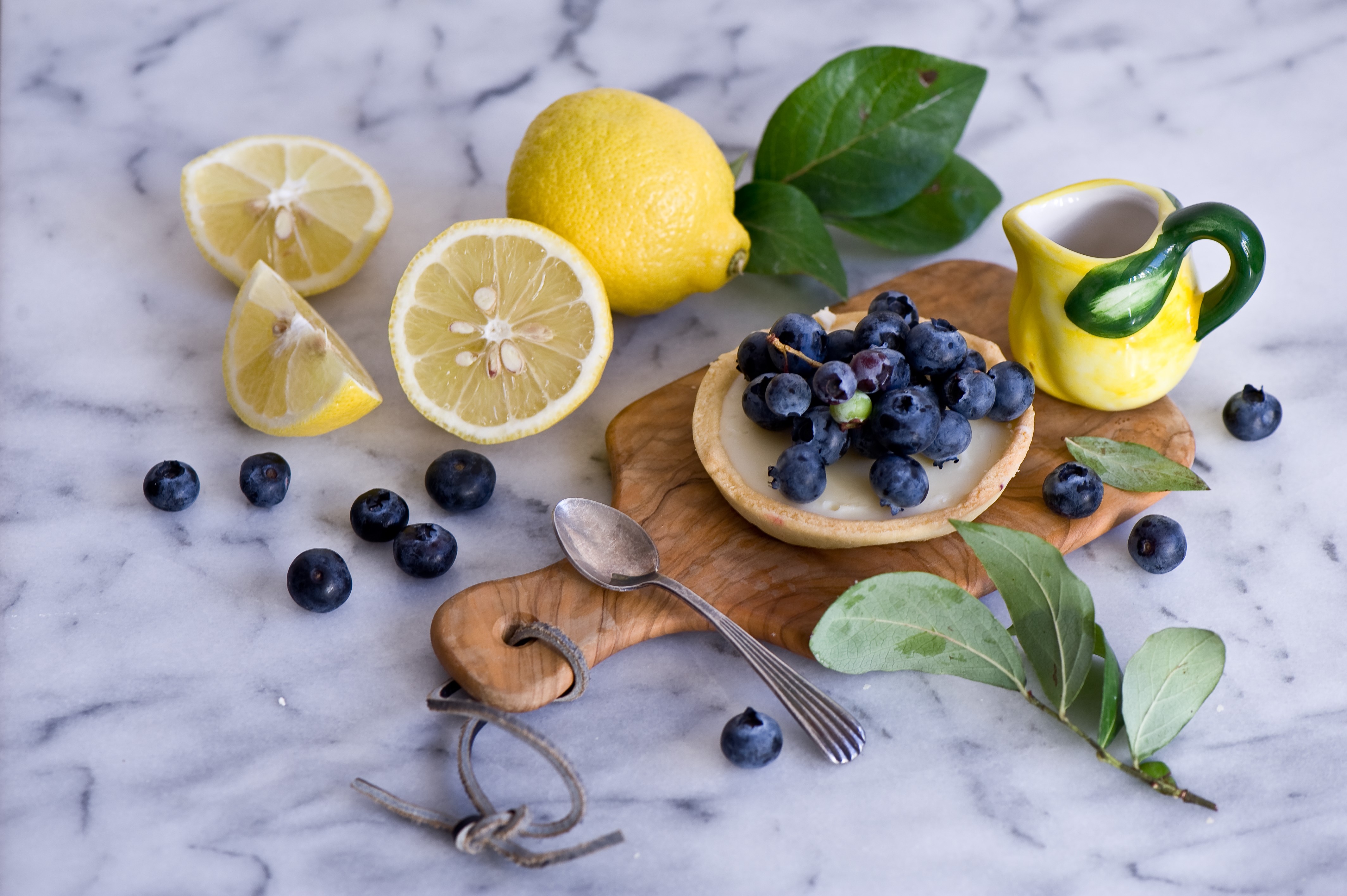 Still-life with blueberries, lemons, and a jug container HD Wallpaper