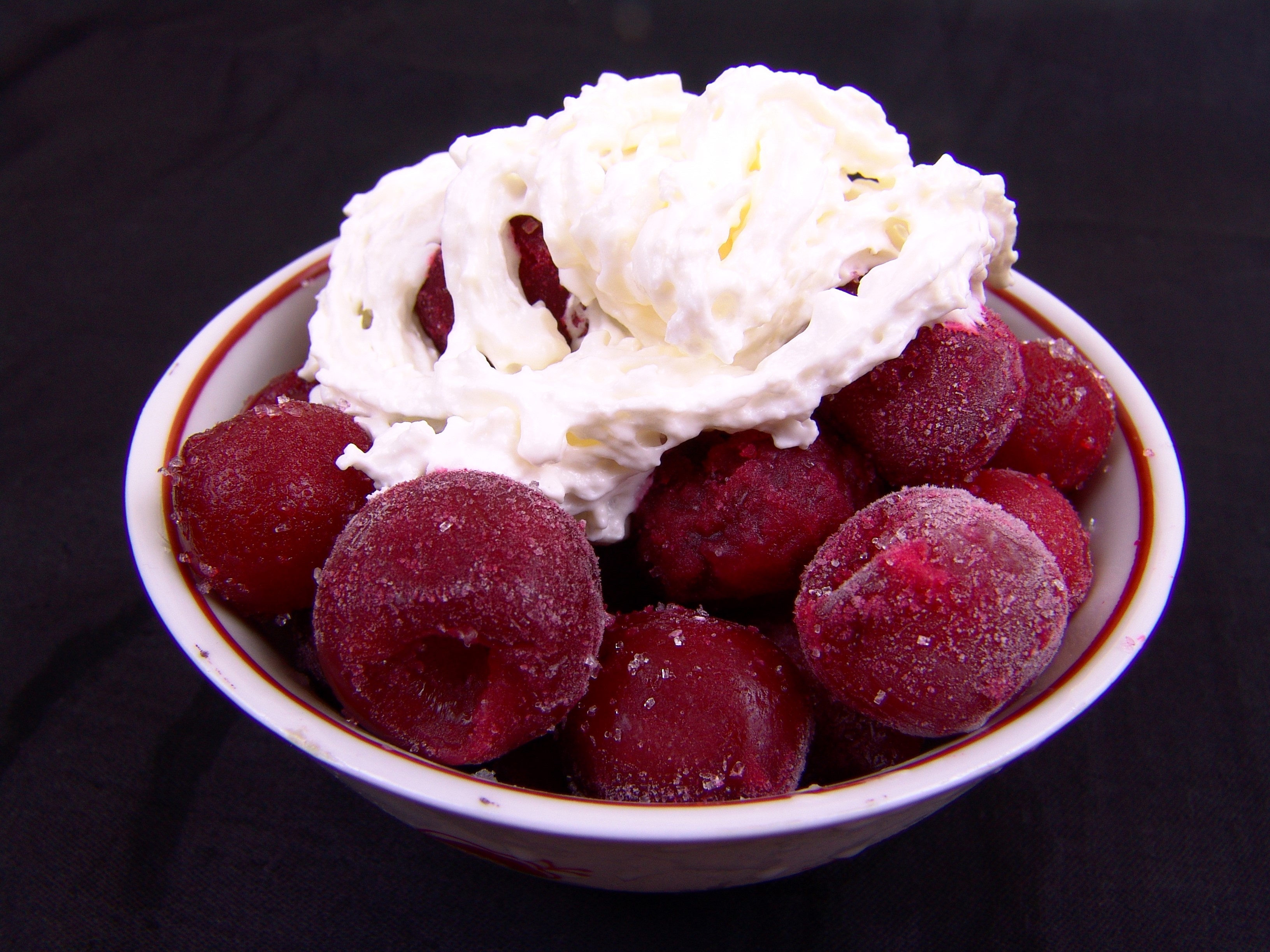 Frozen cherries with whipped cream in a bowl HD Wallpaper
