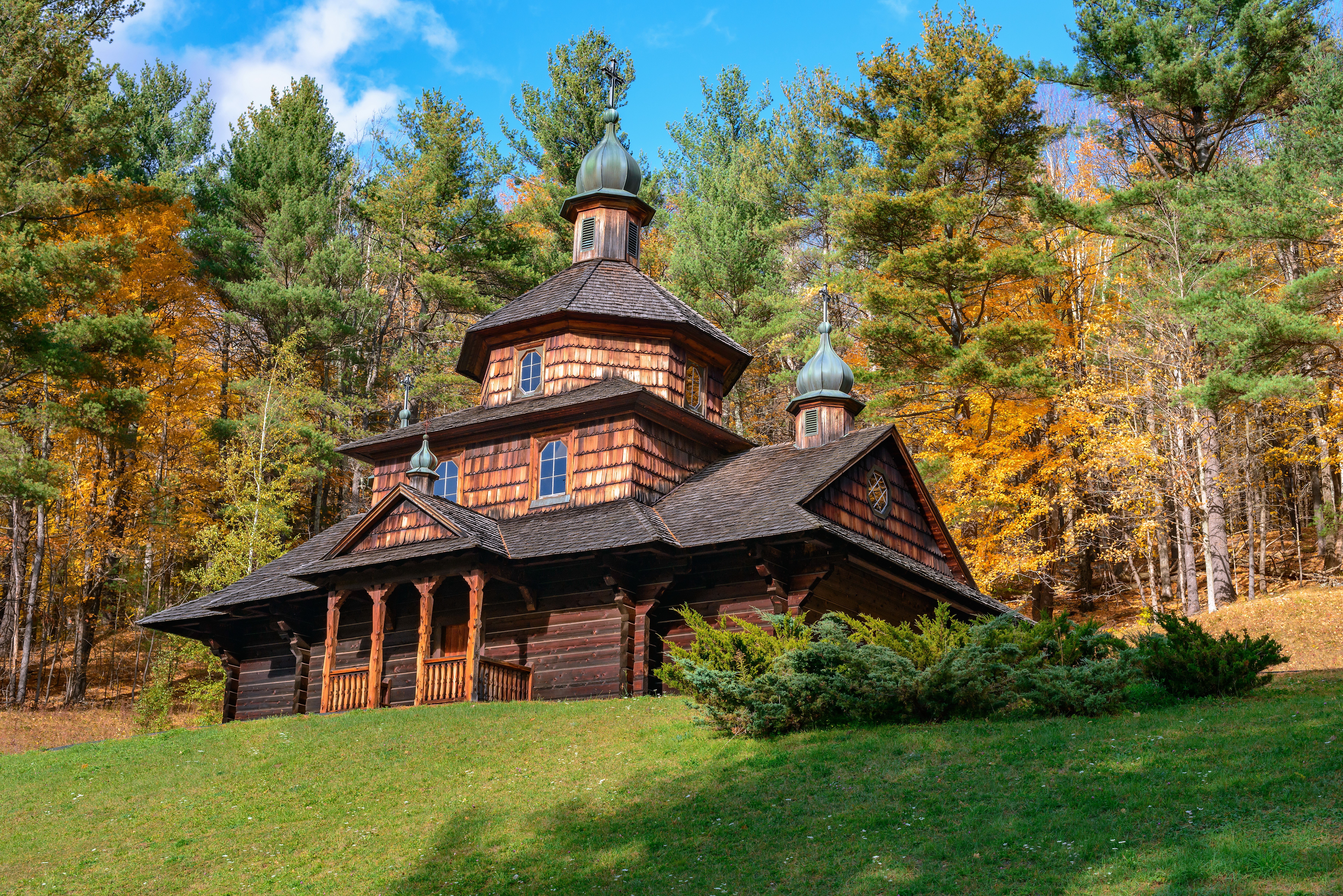 Old wooden Ukrainian church in autumn forest HD Wallpaper