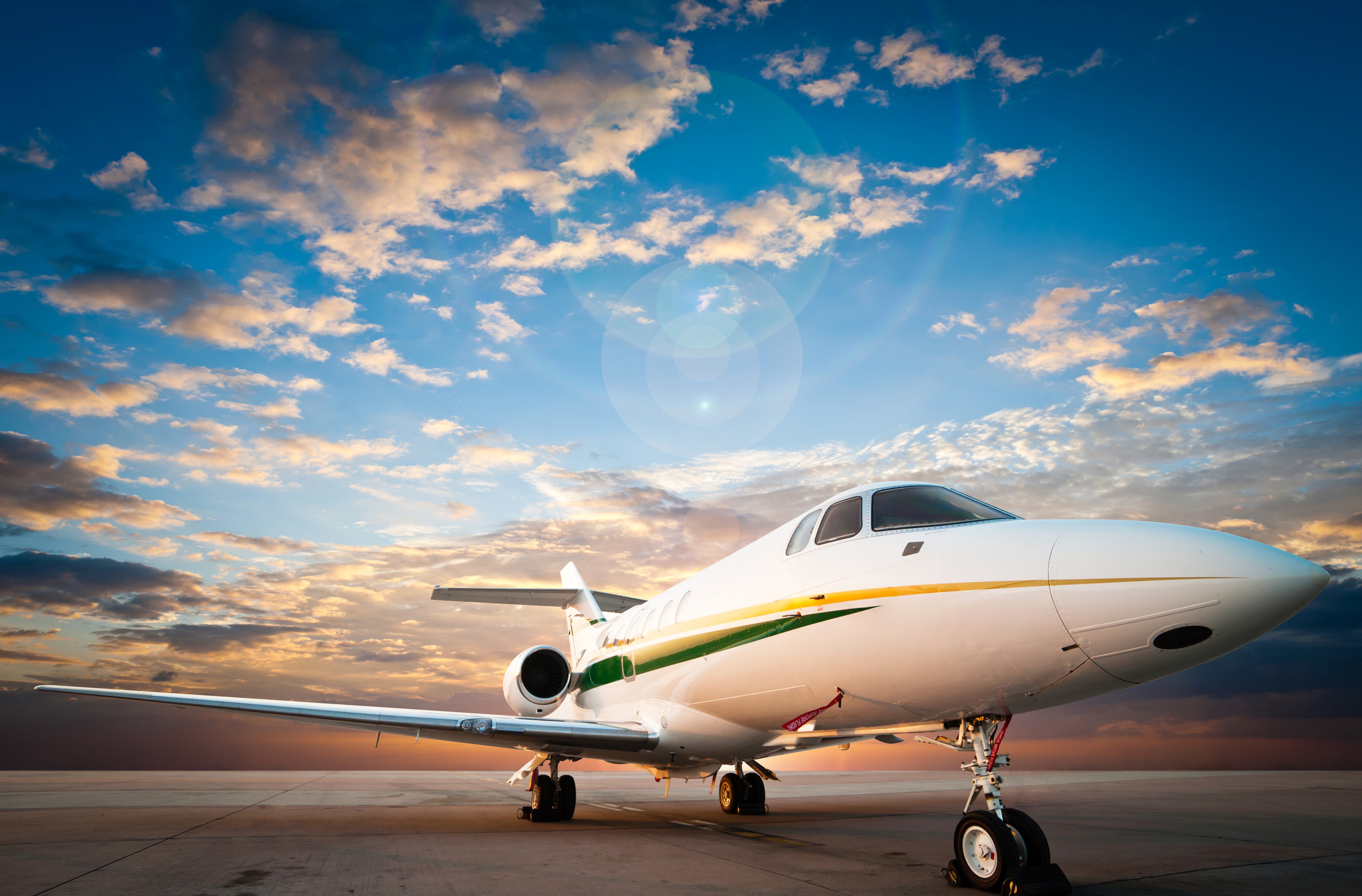 Private jet airplane on tarmac at sunset HD Wallpaper