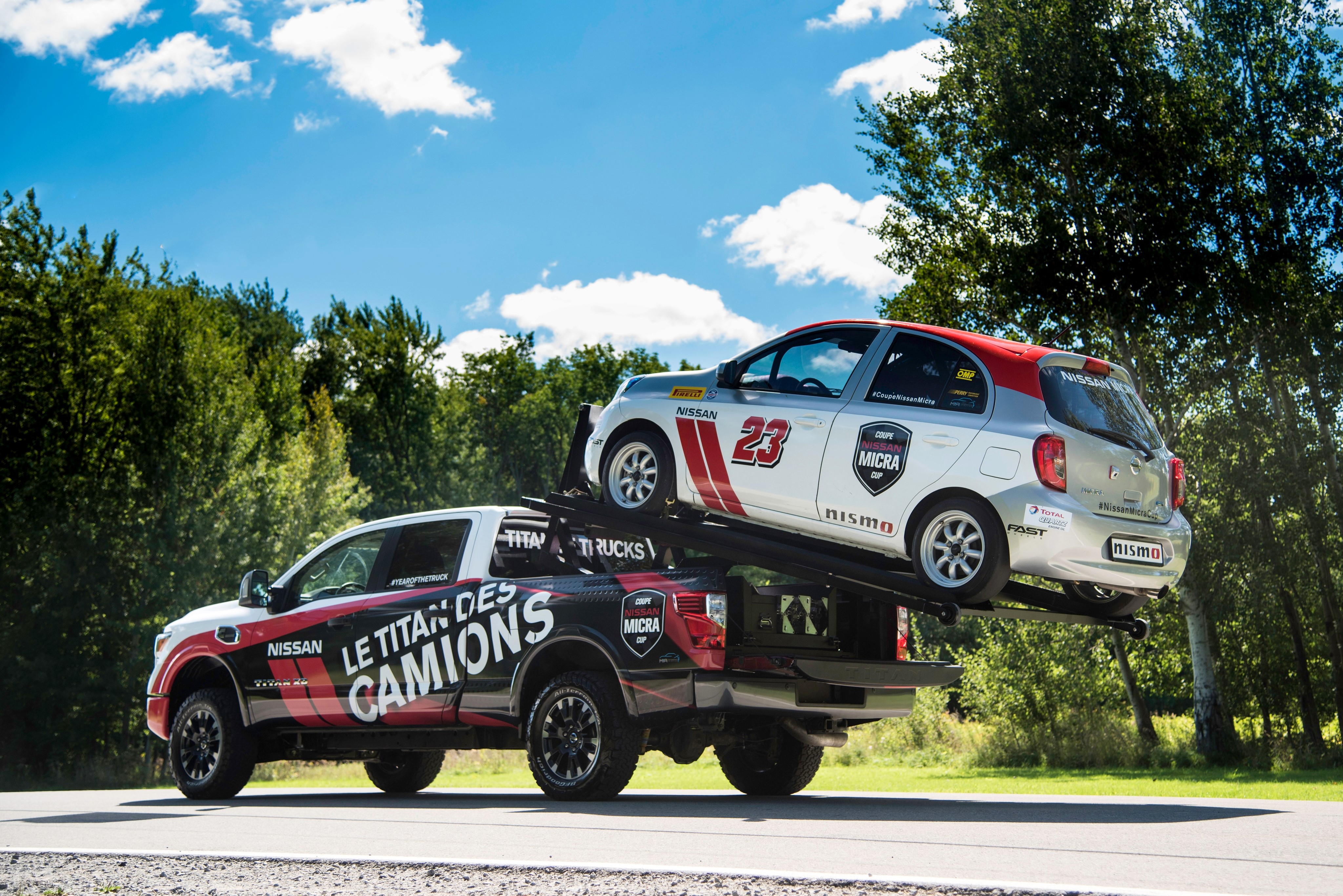 Nissan Titan Trucks carrying Nissan Micra Cup car HD Wallpaper