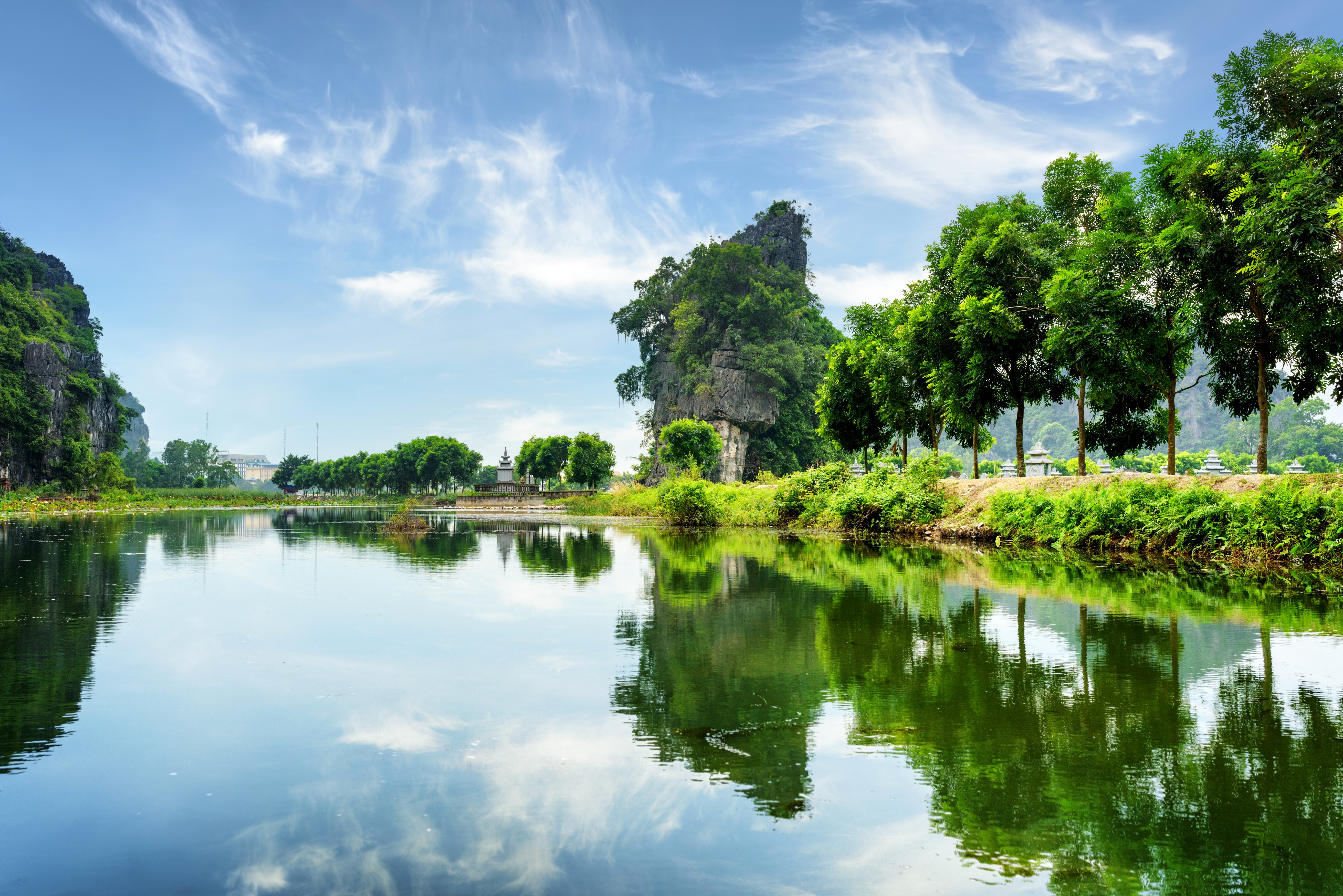 Lake and Crag with Trees under Blue Sky HD Wallpaper