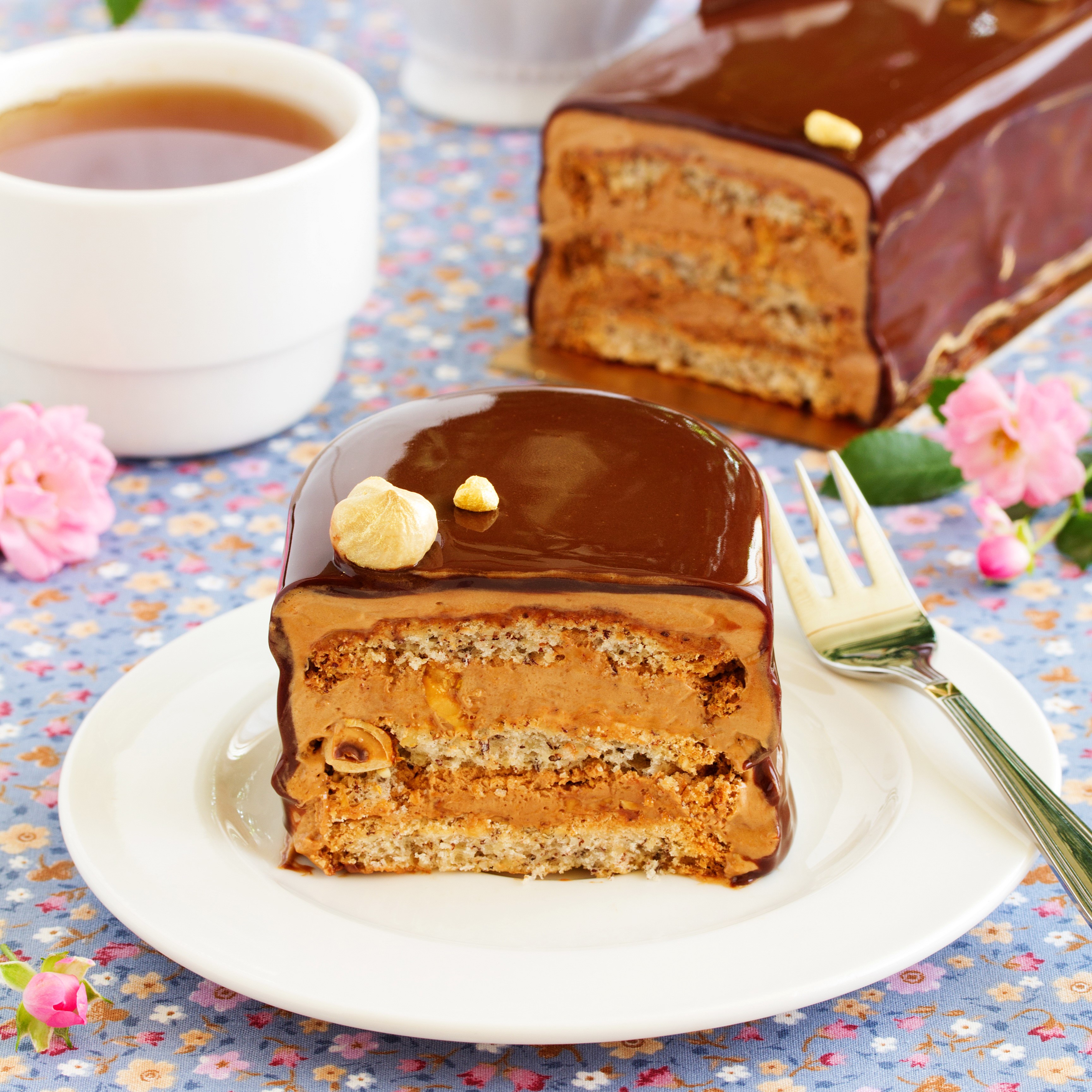 Chocolate hazelnut cake slice with tea HD Wallpaper