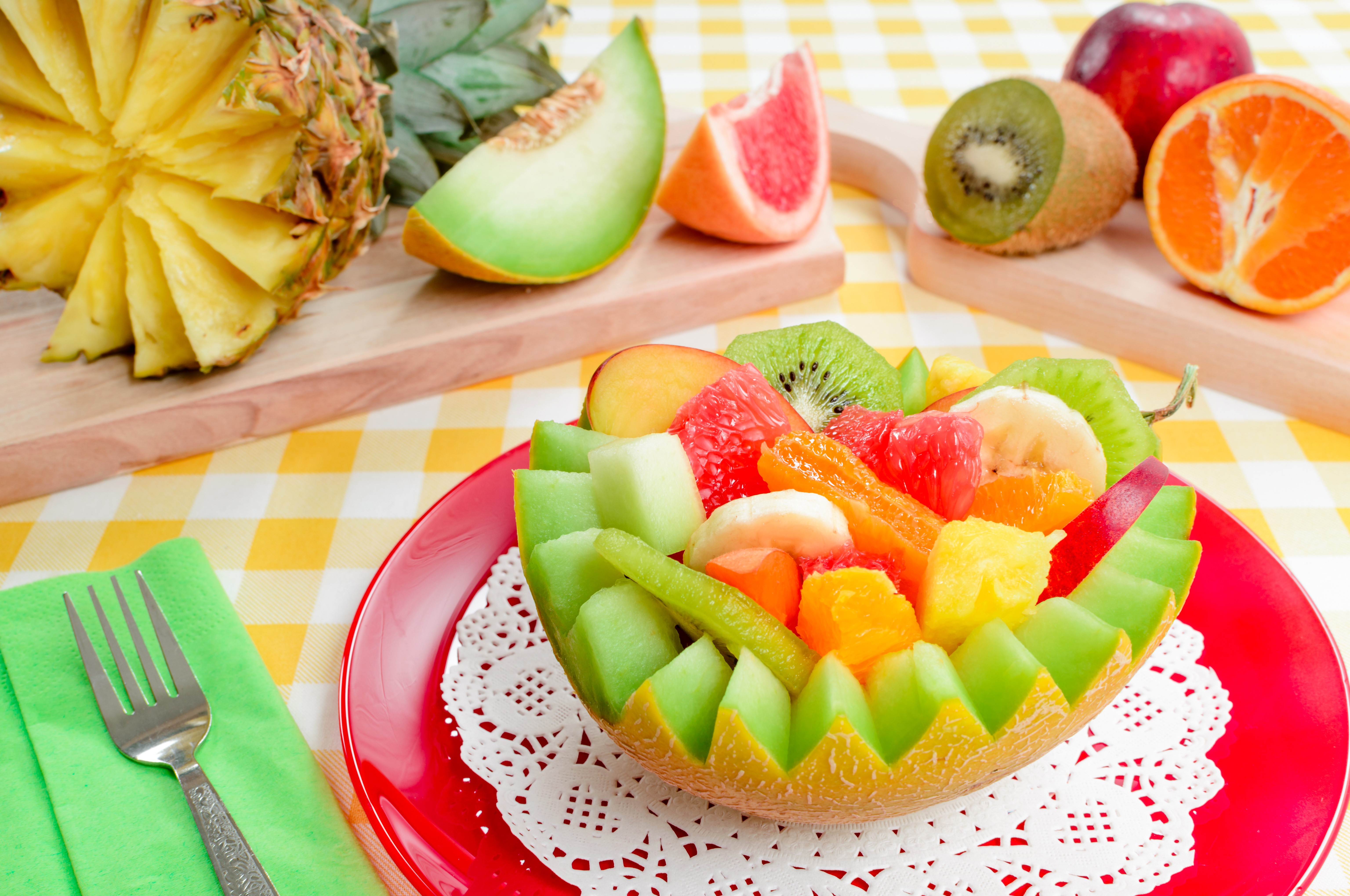 Fruit salad in a melon bowl with pineapple and kiwi HD Wallpaper