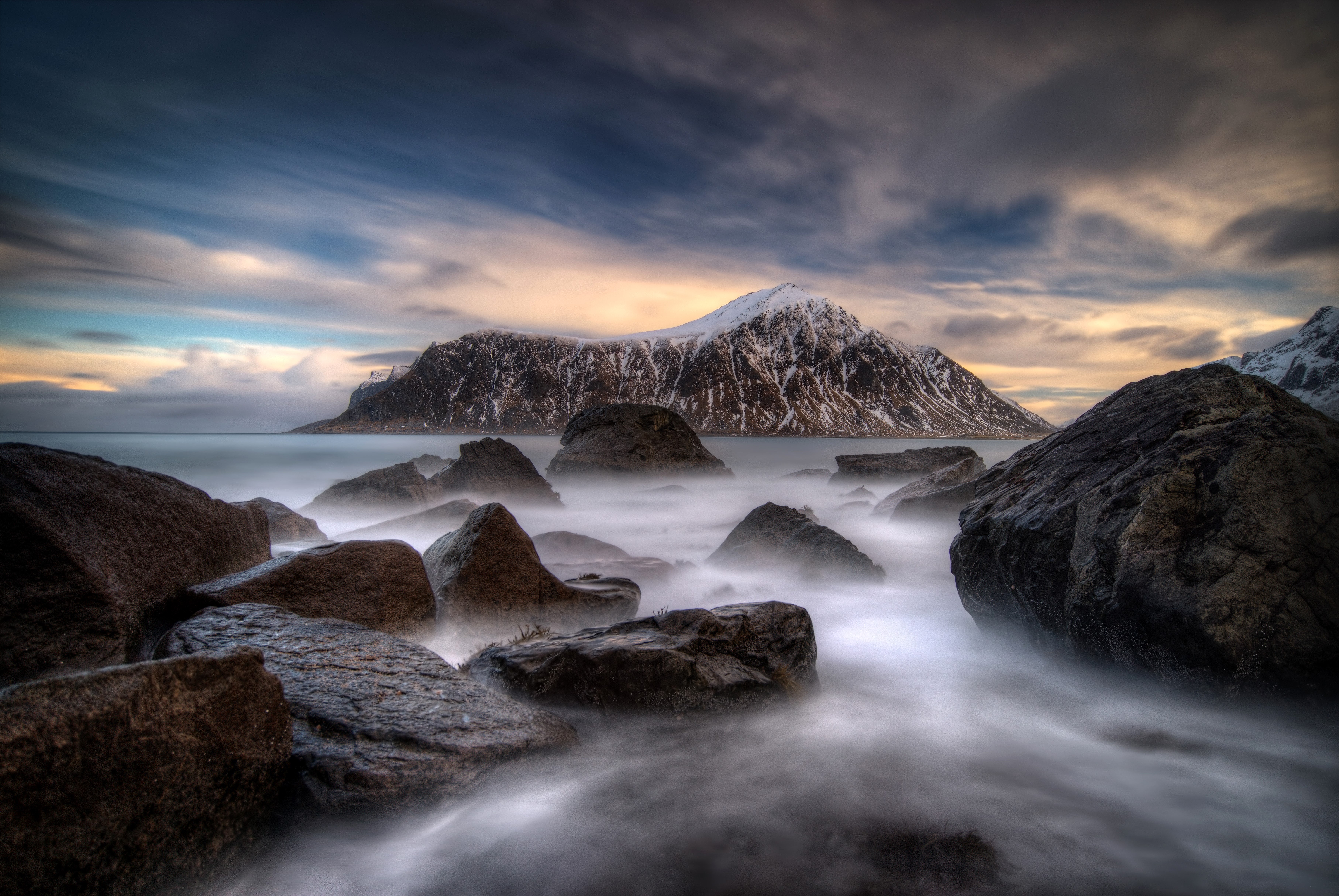 Rocky coast with snow-capped mountain in Lofoten, Norway HD Wallpaper