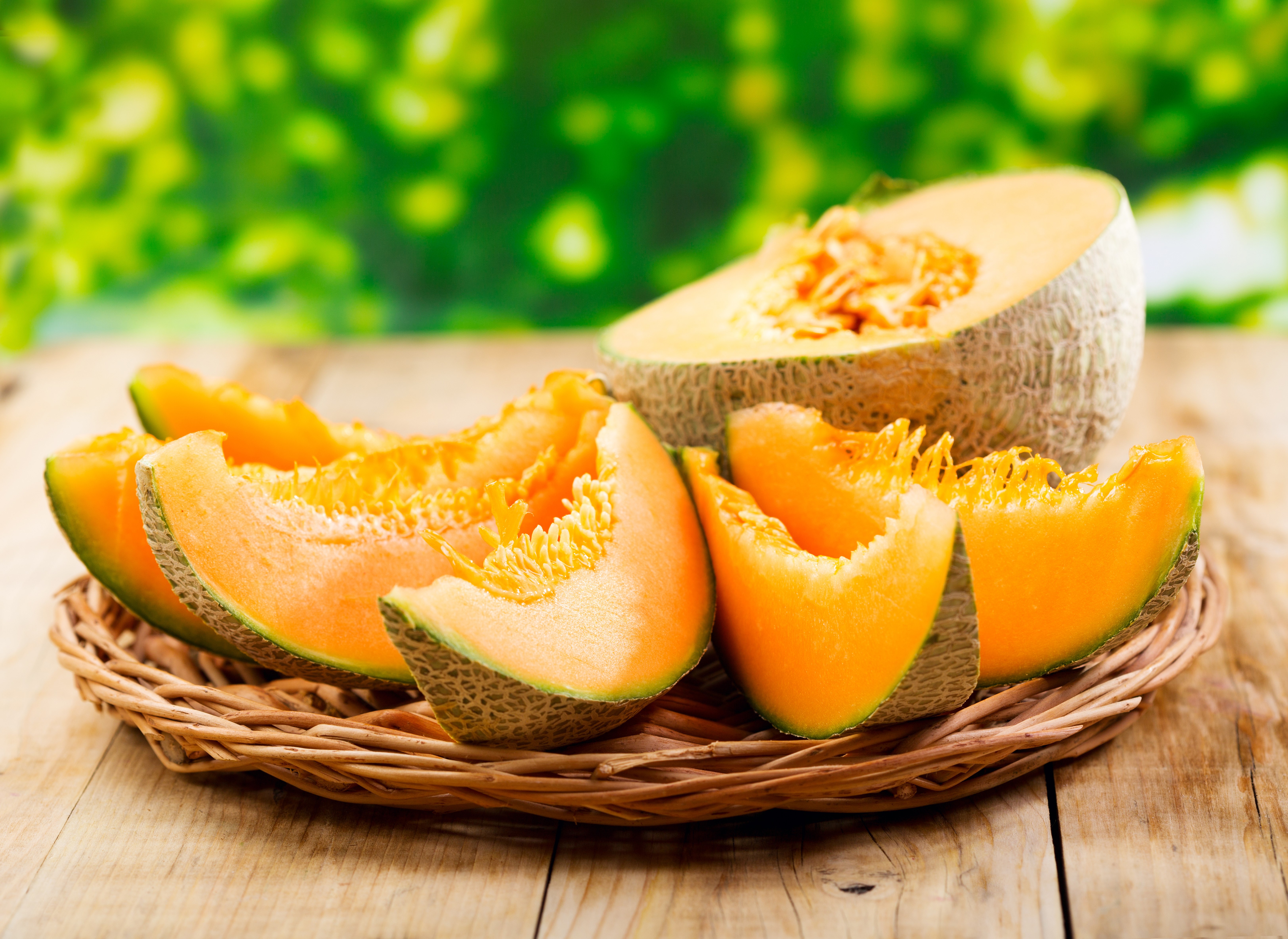 Cantaloupe slices on a woven plate HD Wallpaper