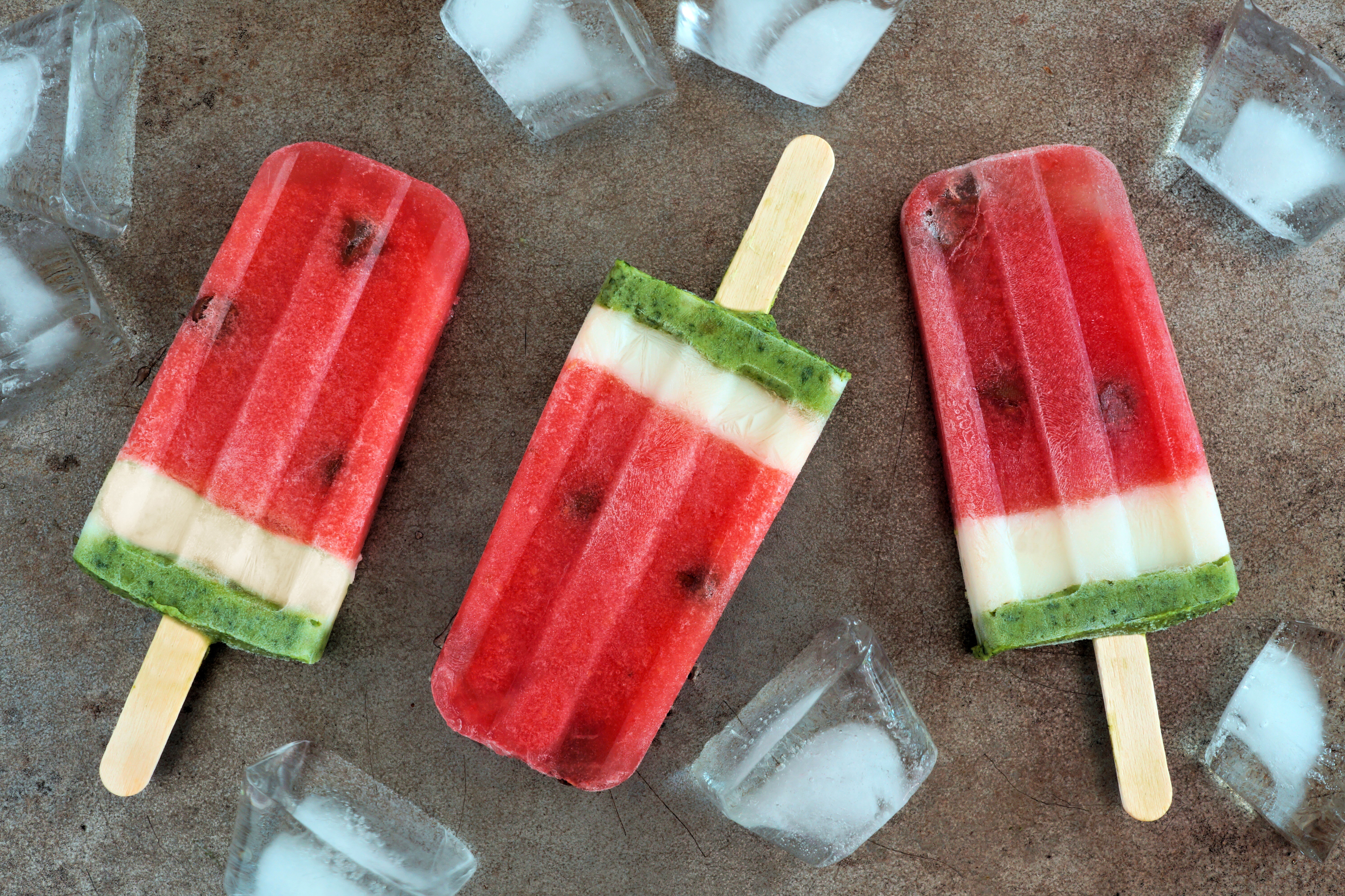 Three watermelon popsicles with ice cubes HD Wallpaper