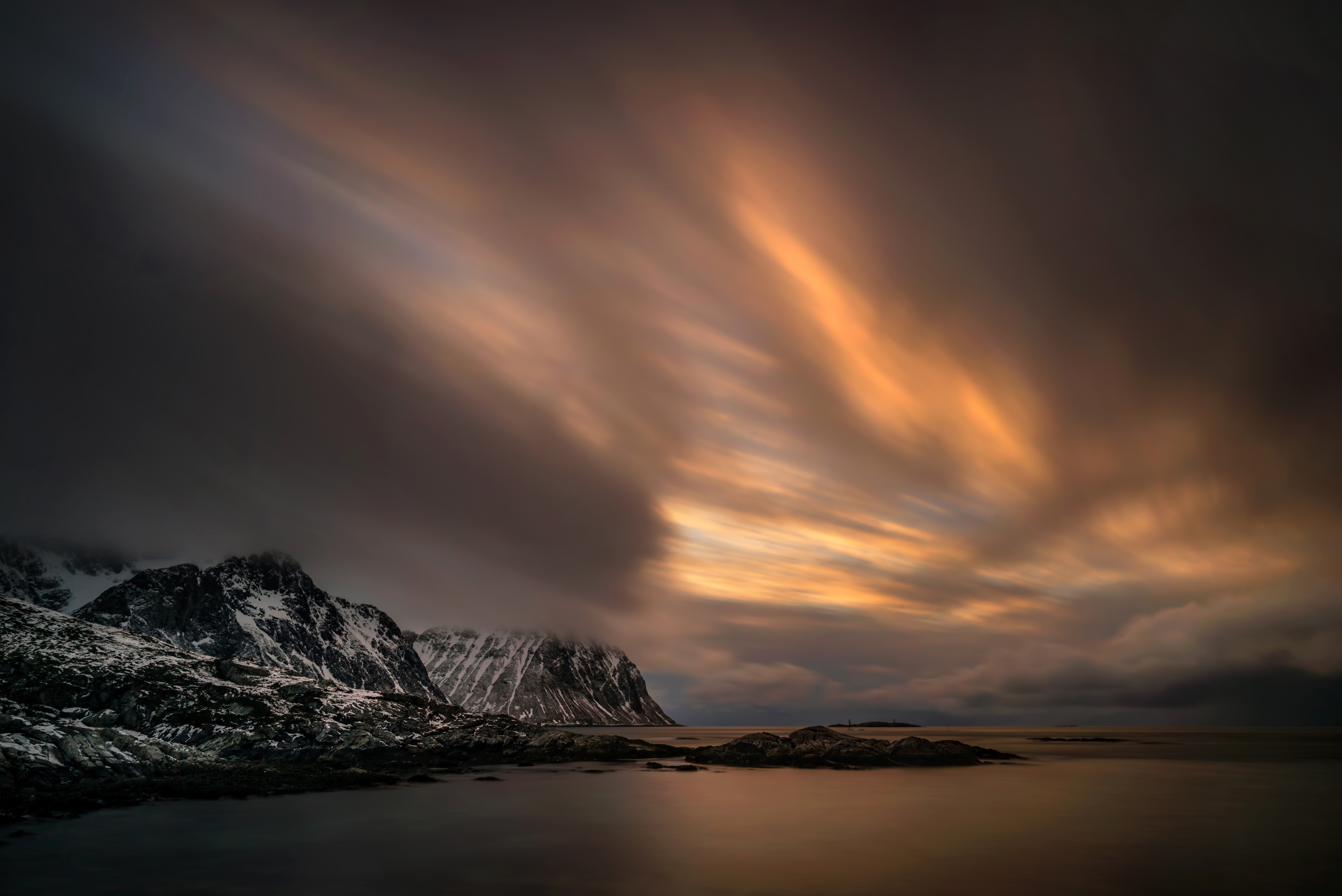 Long exposure of clouds over snowy mountains in Lofoten, Norway HD Wallpaper